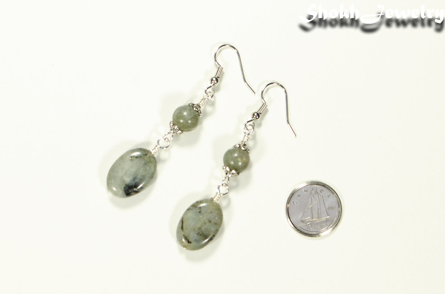 Statement Labradorite Crystal Earrings beside a dime.