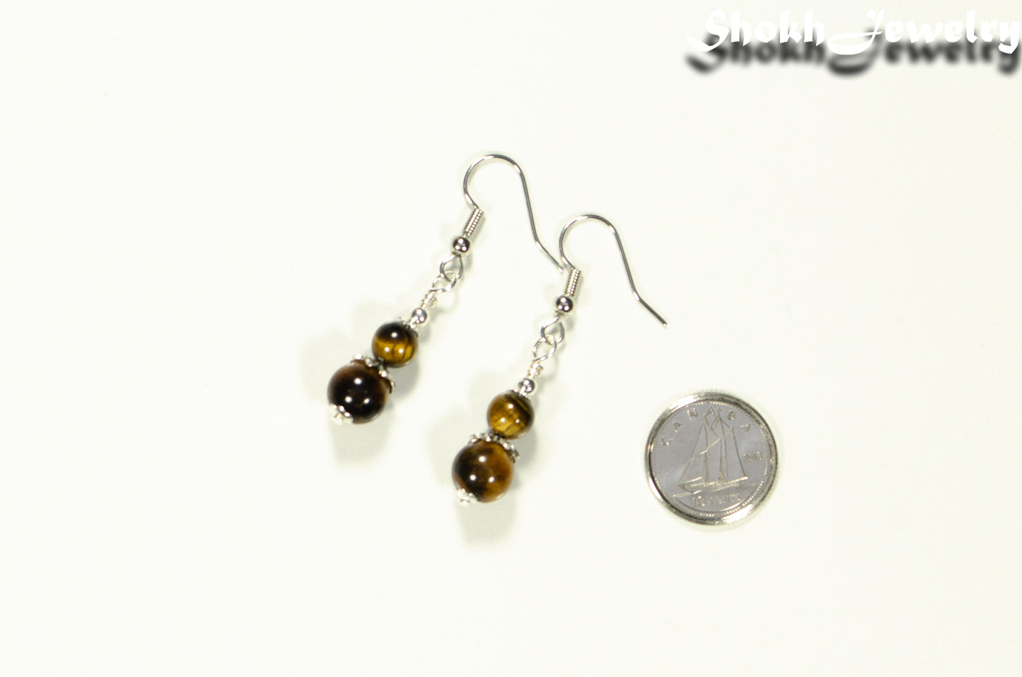 Small Tiger's Eye Earrings beside a dime.