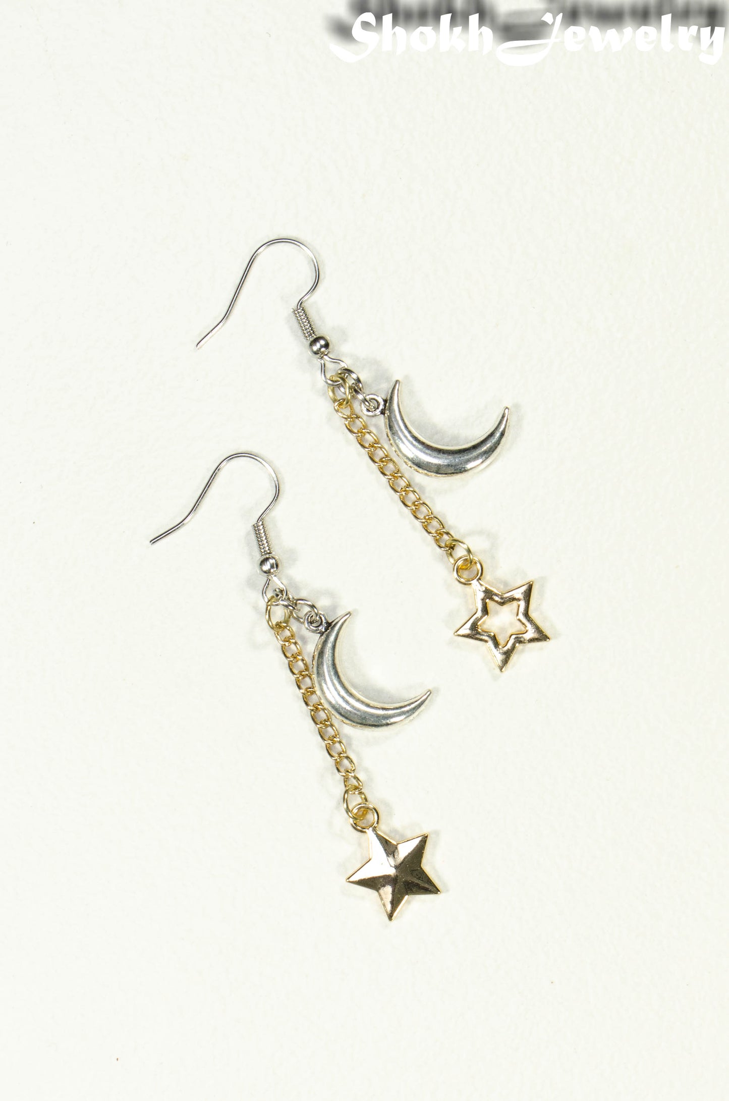 Top view of Crescent Moon and Mismatched Gold Star Earrings.