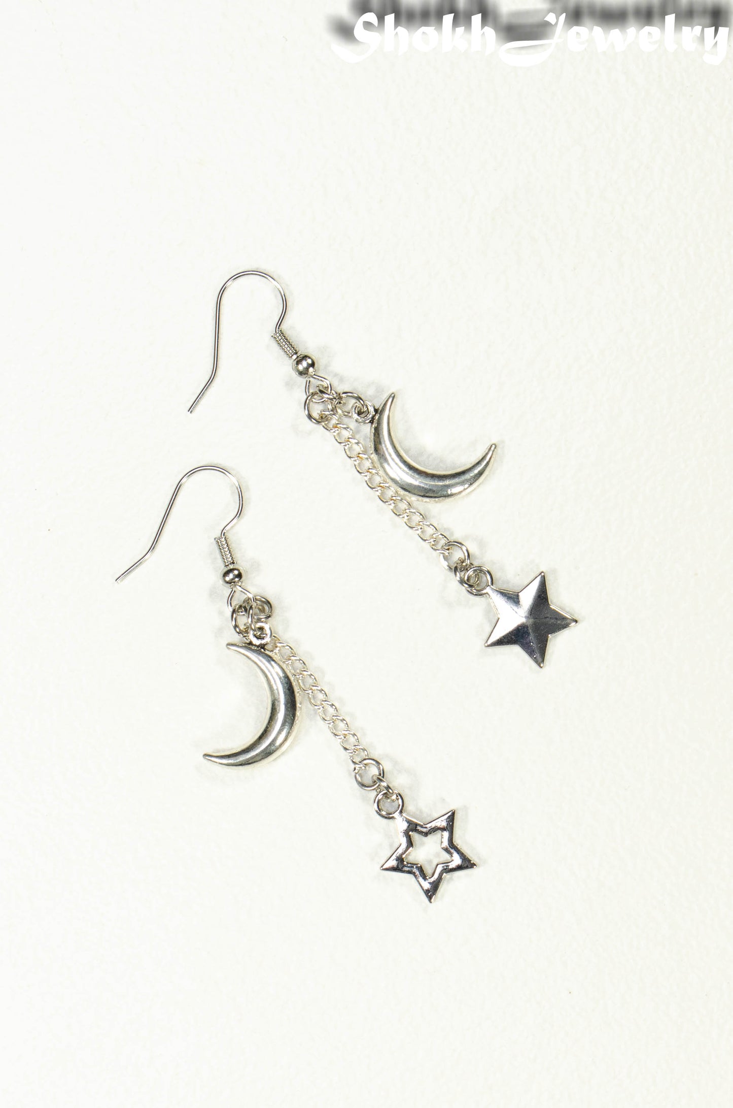 Top view of Crescent Moon and Mismatched Star Earrings.