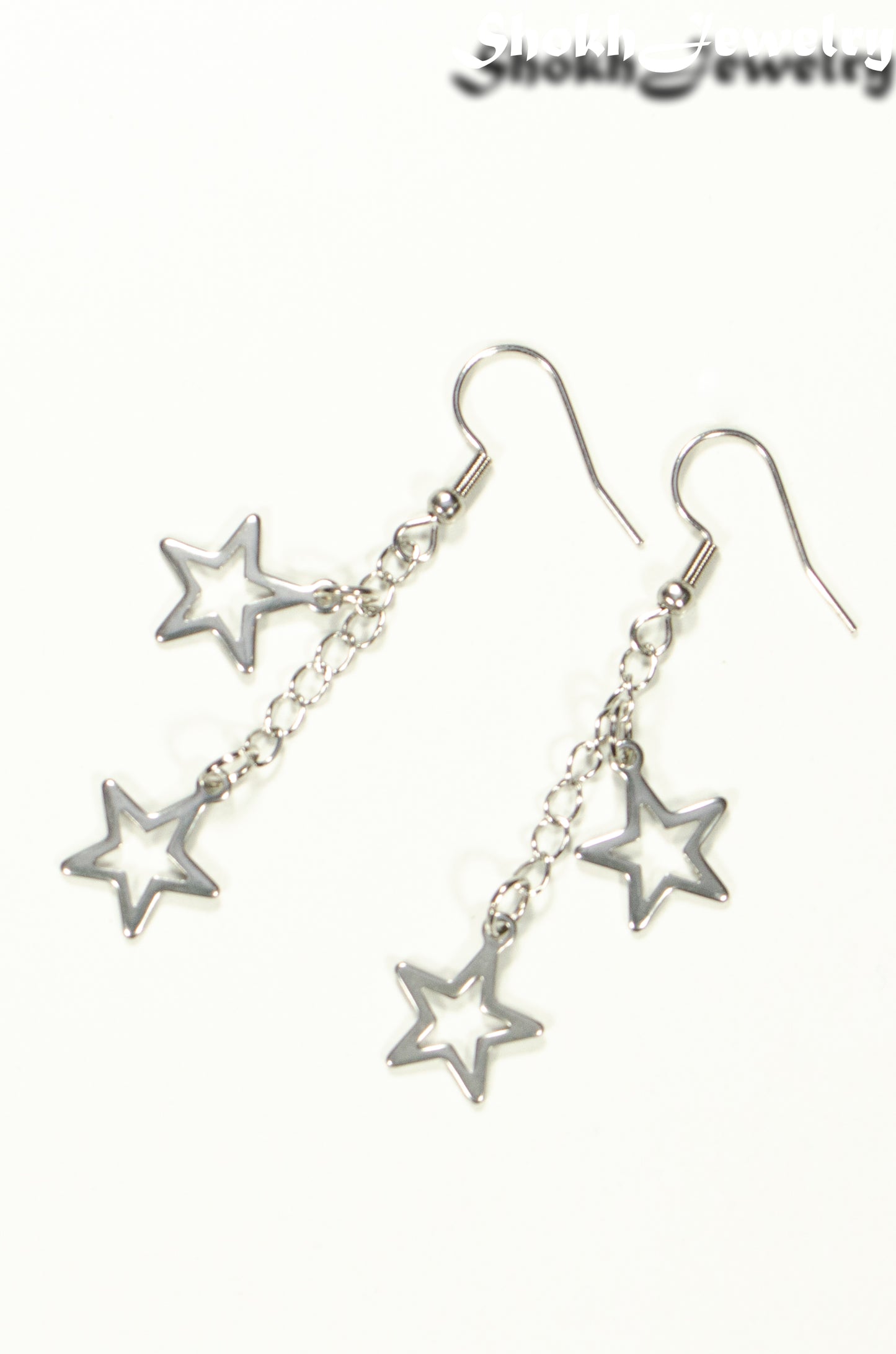 Top view of Stainless steel chain and 2 star earrings.