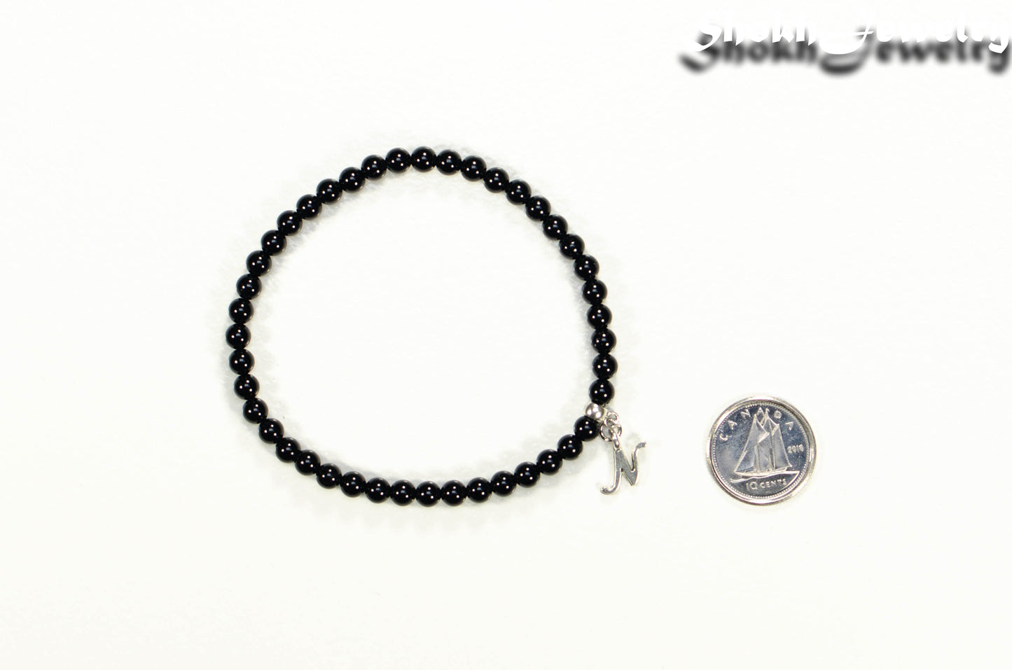 Black Obsidian Bracelet with Initial beside a dime