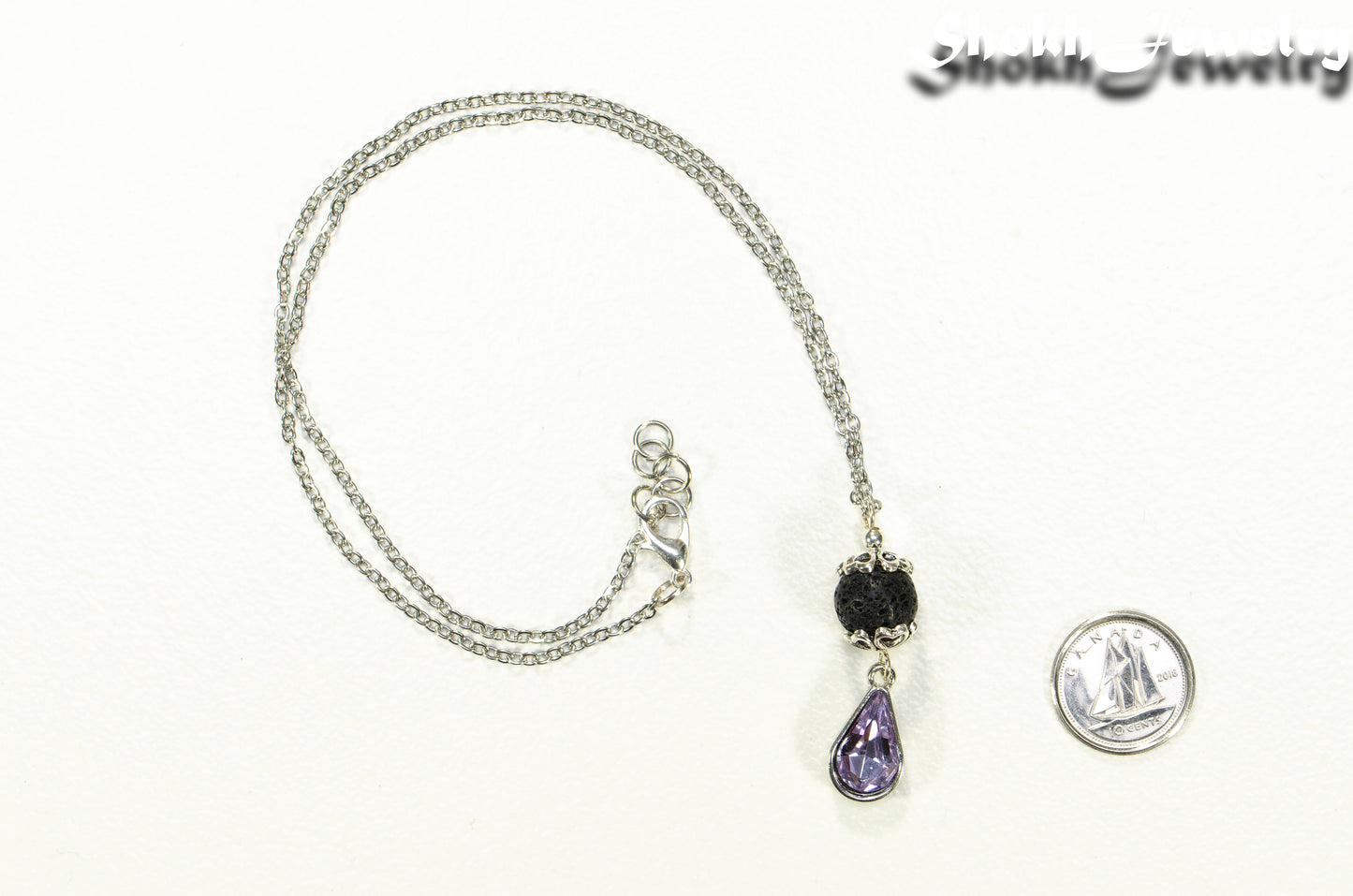 Lava Rock and Teardrop June Birthstone Choker Necklace beside a dime.