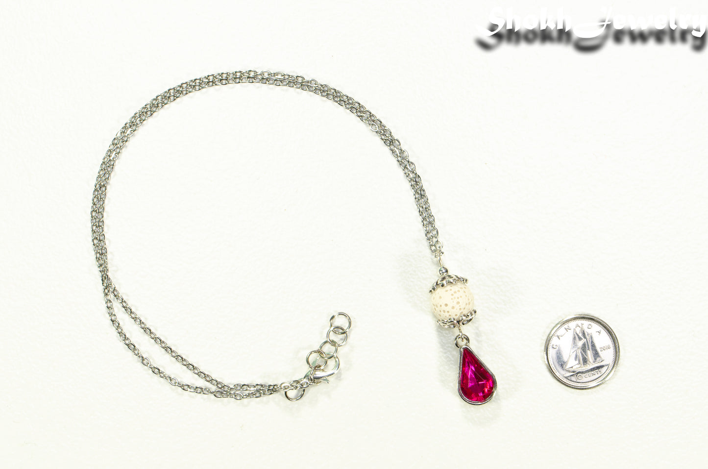 Lava Rock and Teardrop October Birthstone Choker Necklace beside a dime.