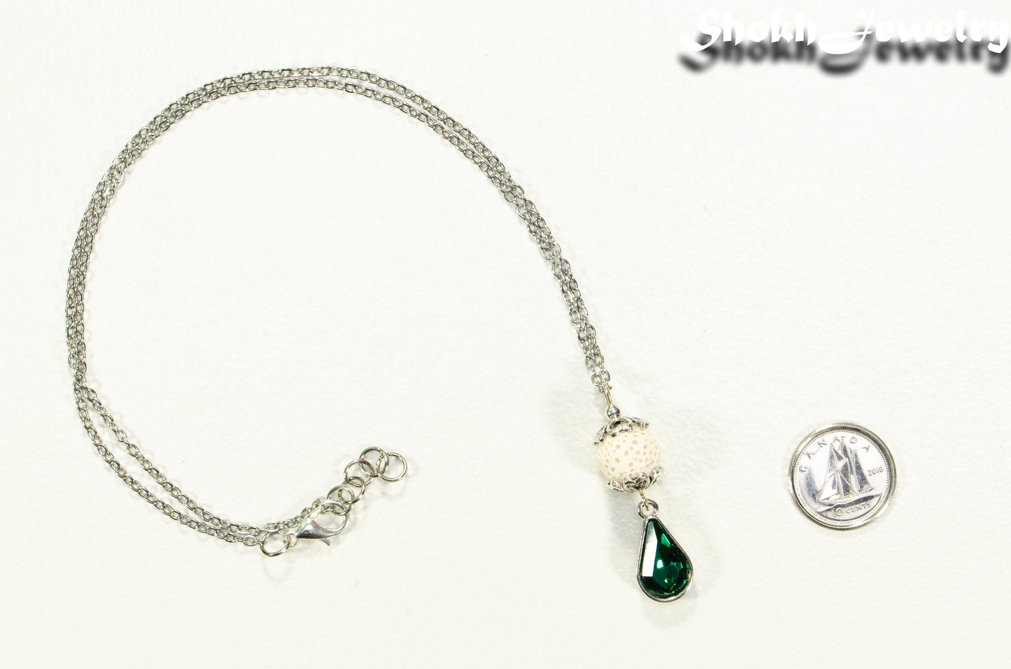 Lava Rock and Teardrop May Birthstone Choker Necklace beside a dime.