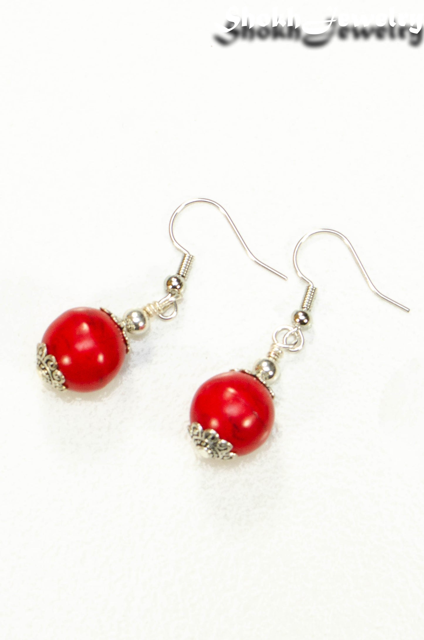 Top view of 12mm Red Howlite Dangle Earrings.