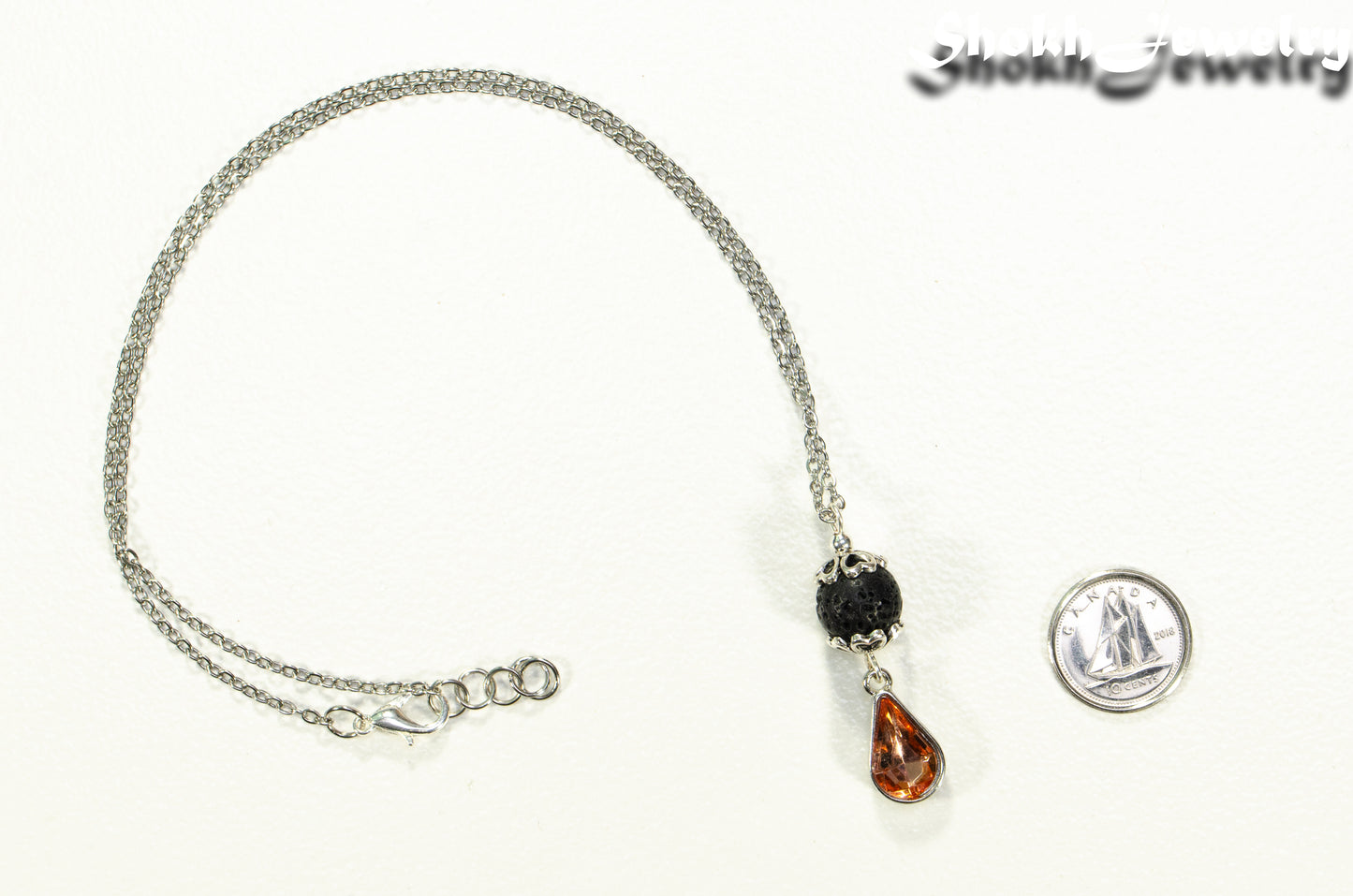 Lava Rock and Teardrop July Birthstone Choker Necklace beside a dime.