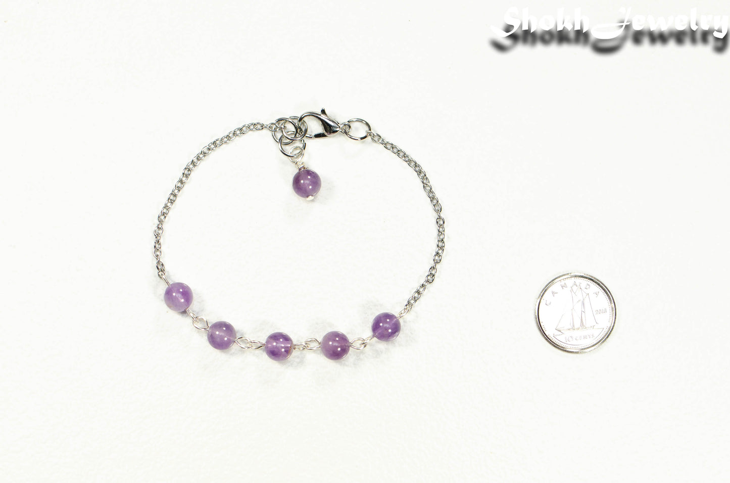 Amethyst and Stainless Steel Chain Anklet beside a dime.