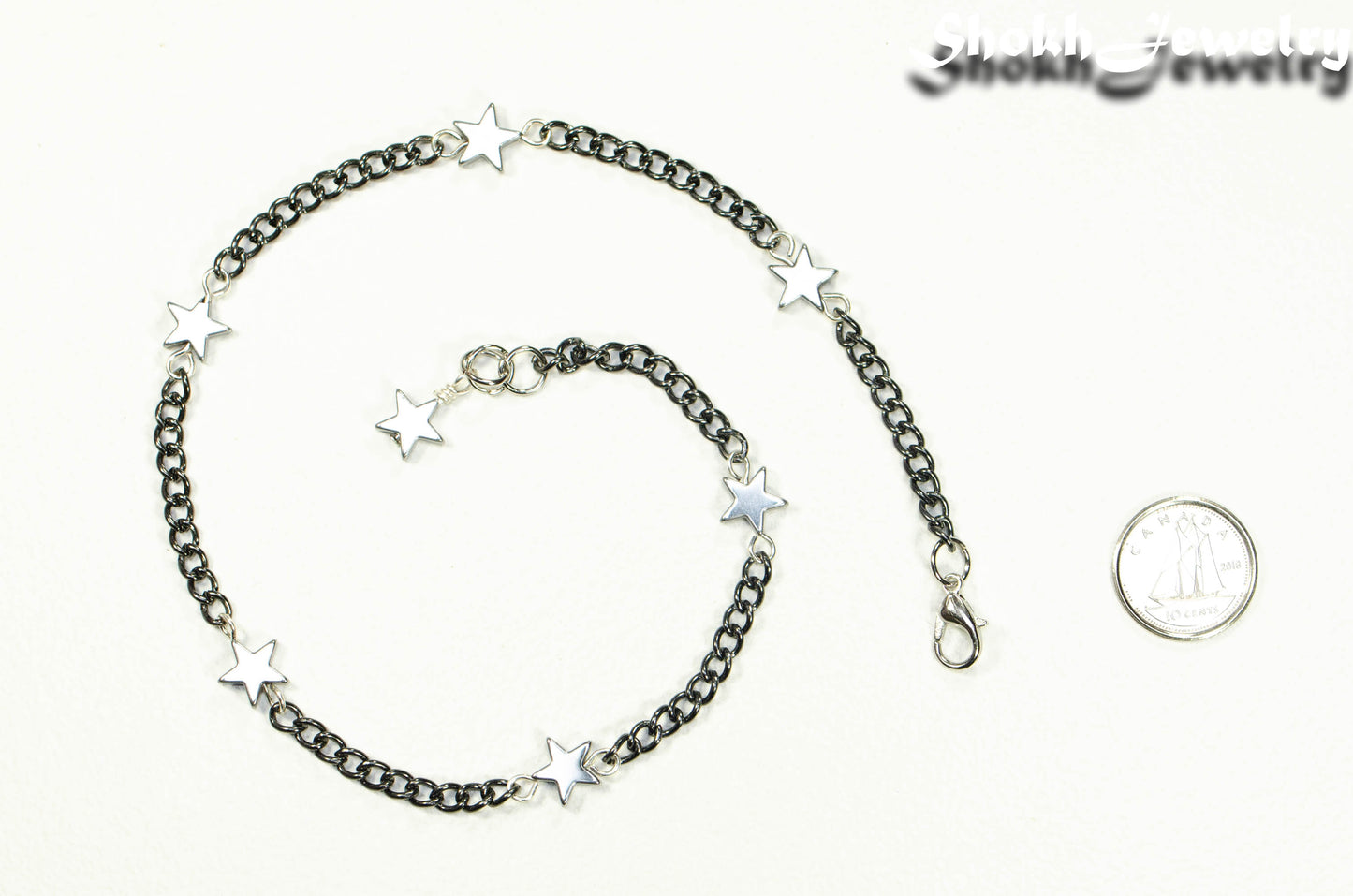 Natural Hematite Star and Black Chain Anklet beside a dime.