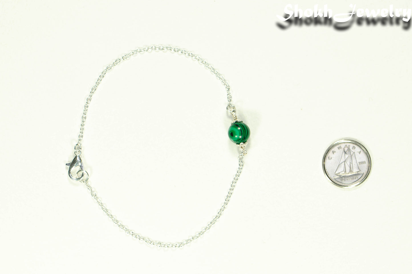 Minimal Malachite Bracelet beside a dime.