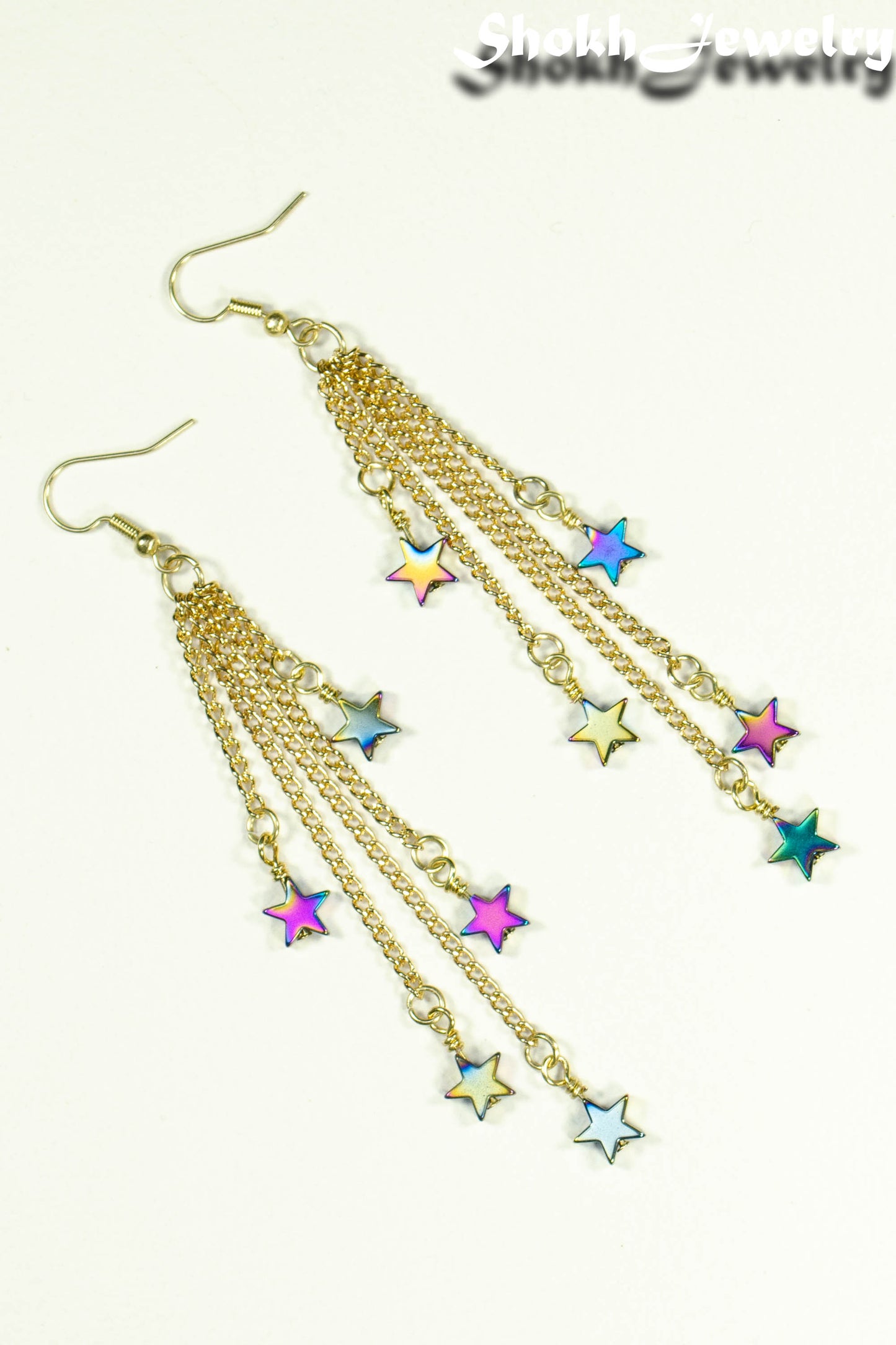 Top view of Extra Long Rainbow Hematite Star Earrings.