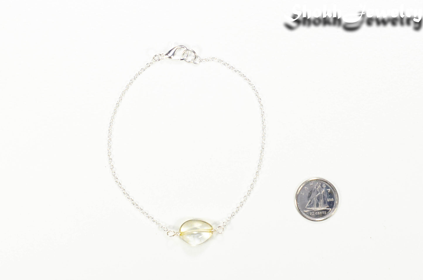 Minimal Citrine Bracelet beside a dime.