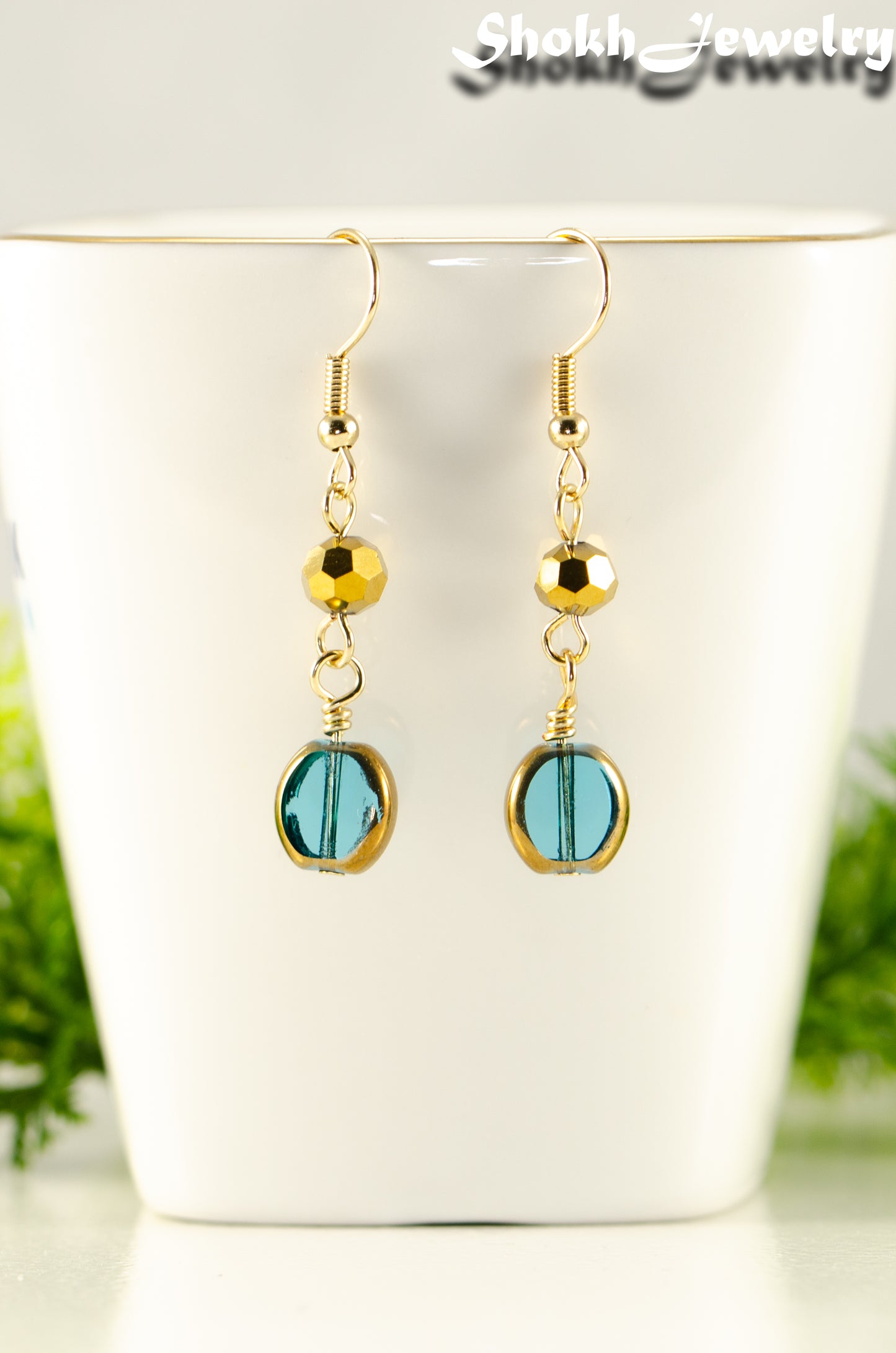 Close up of Teal and Gold Glass Bead Earrings.