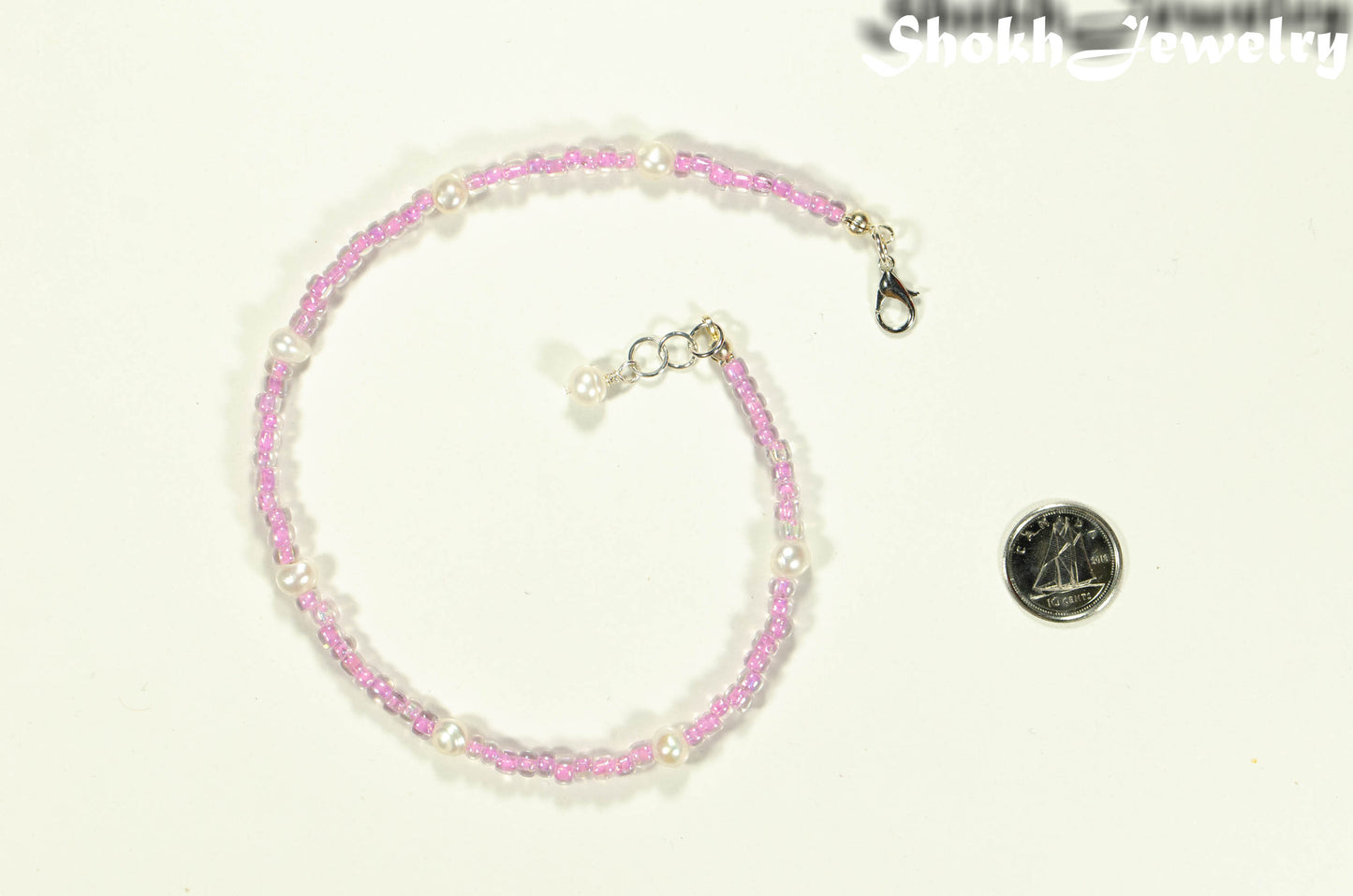 Freshwater Pearl and Pink Seed Bead Anklet beside a dime.