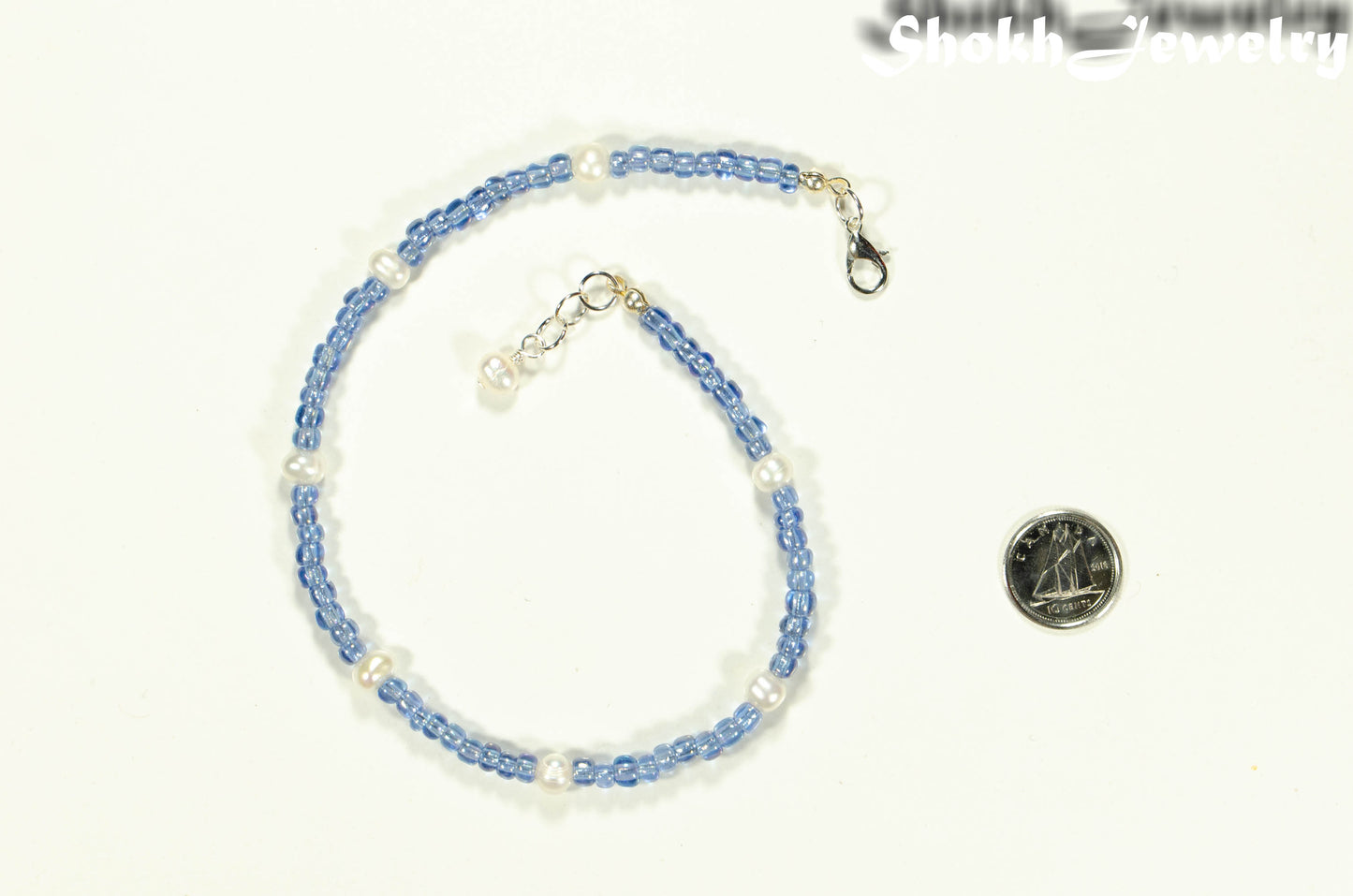 Freshwater Pearl and Blue Seed Bead Anklet beside a dime.