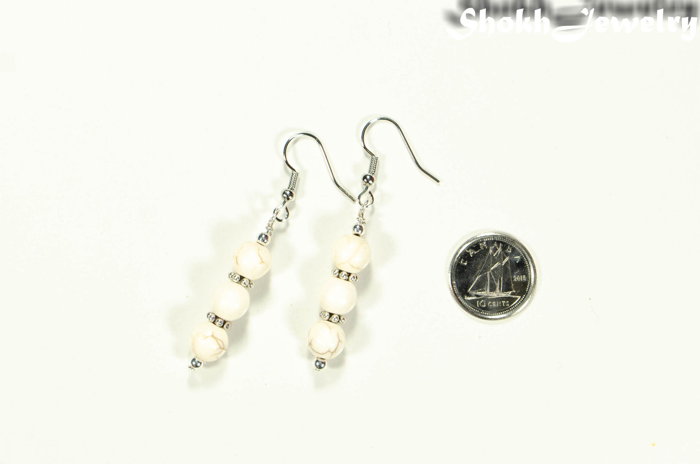 Natural White Howlite Beaded Bar Earrings beside a dime