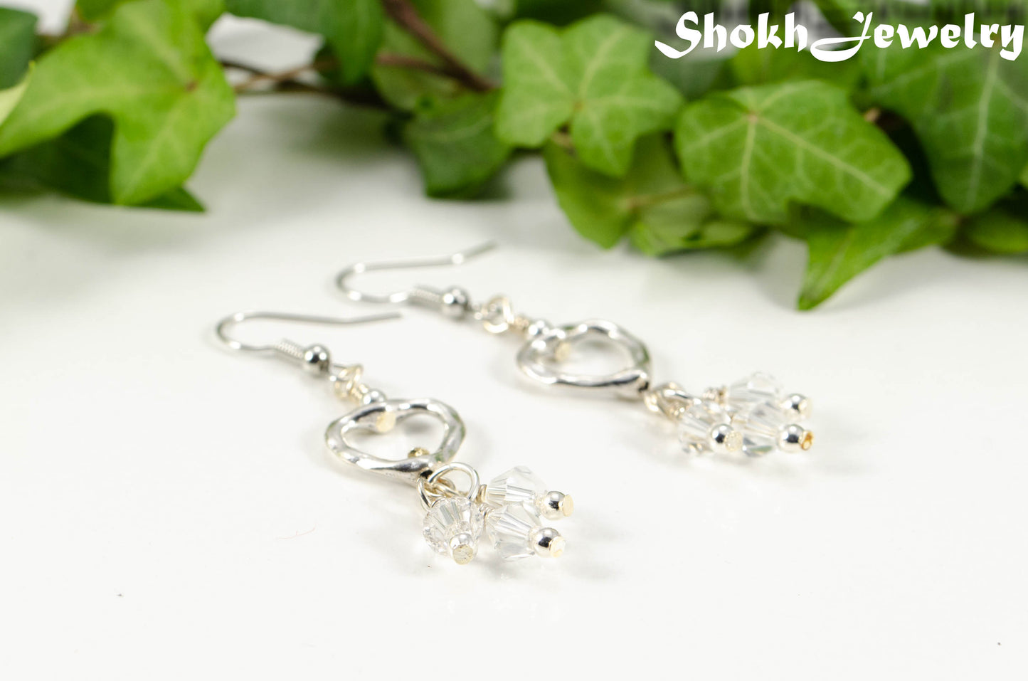 Close up of Silver Plated Heart and Clear Glass Crystal Cluster Earrings.