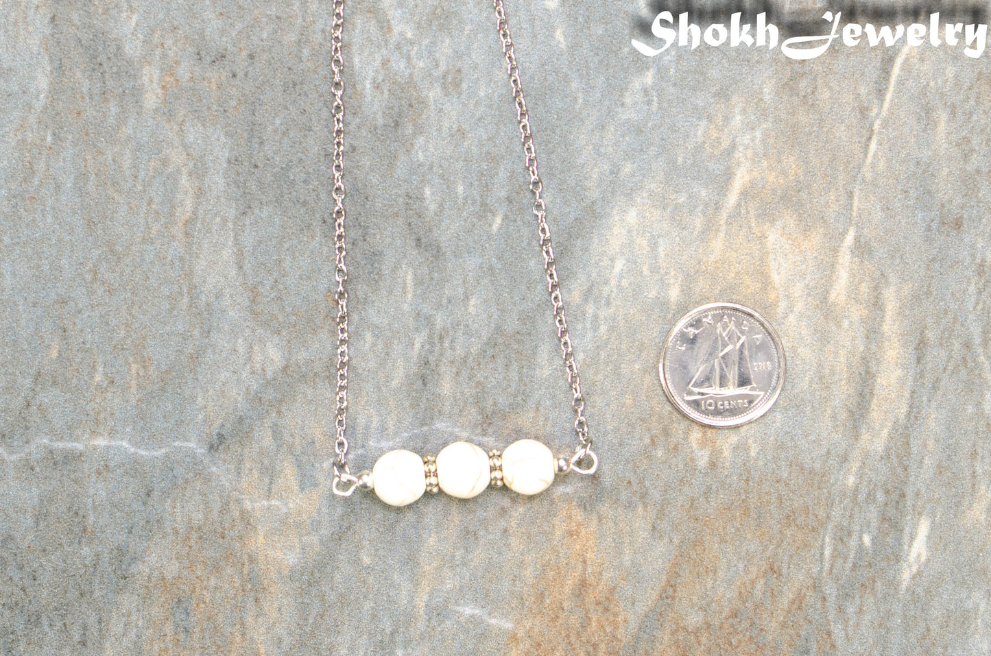White Howlite and Dainty Chain Choker Necklace beside a dime.