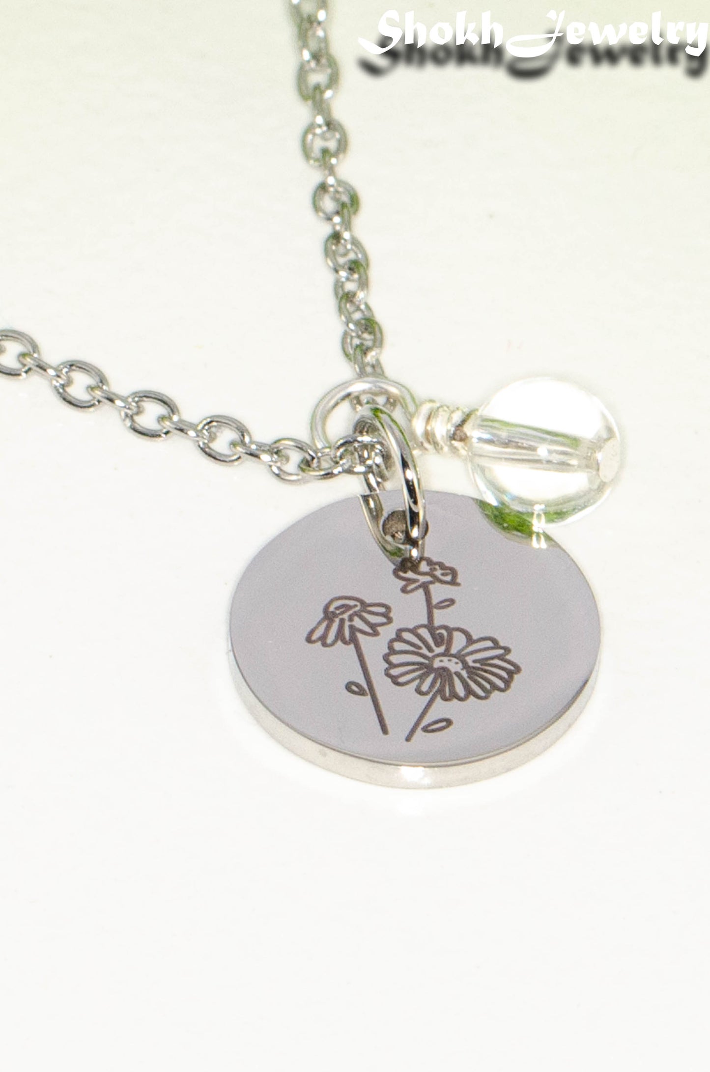 Close up of April Birth Flower Necklace with Clear Quartz Birthstone Pendant.