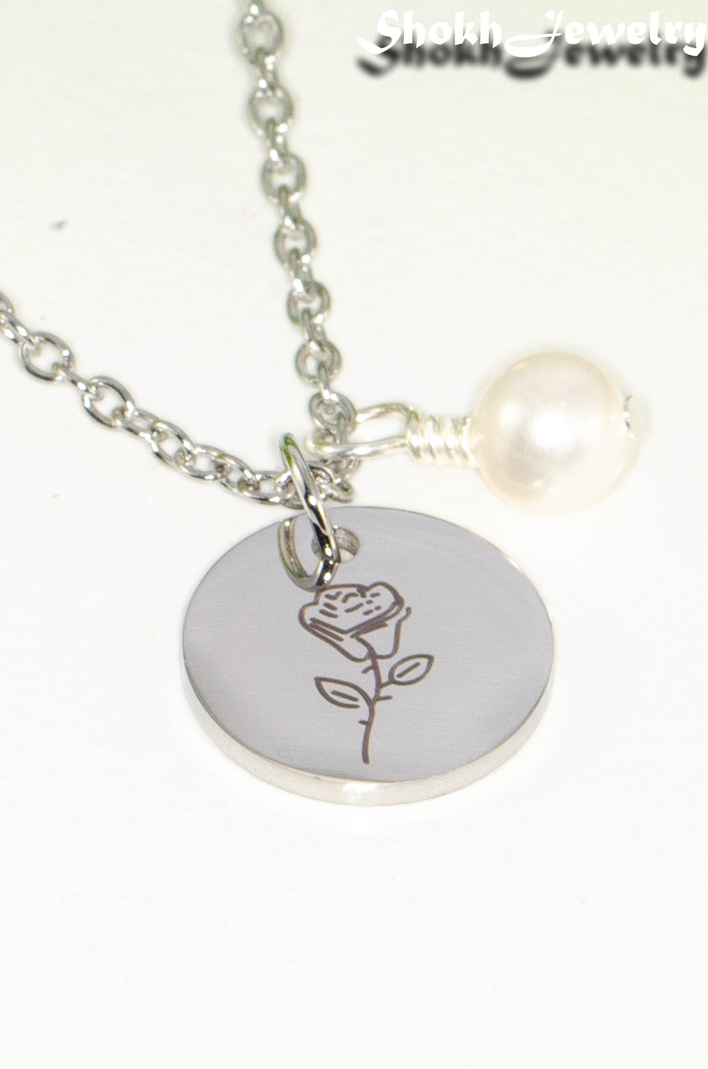 Close up of June Birth Flower Necklace with Freshwater Pearl Birthstone Pendant.
