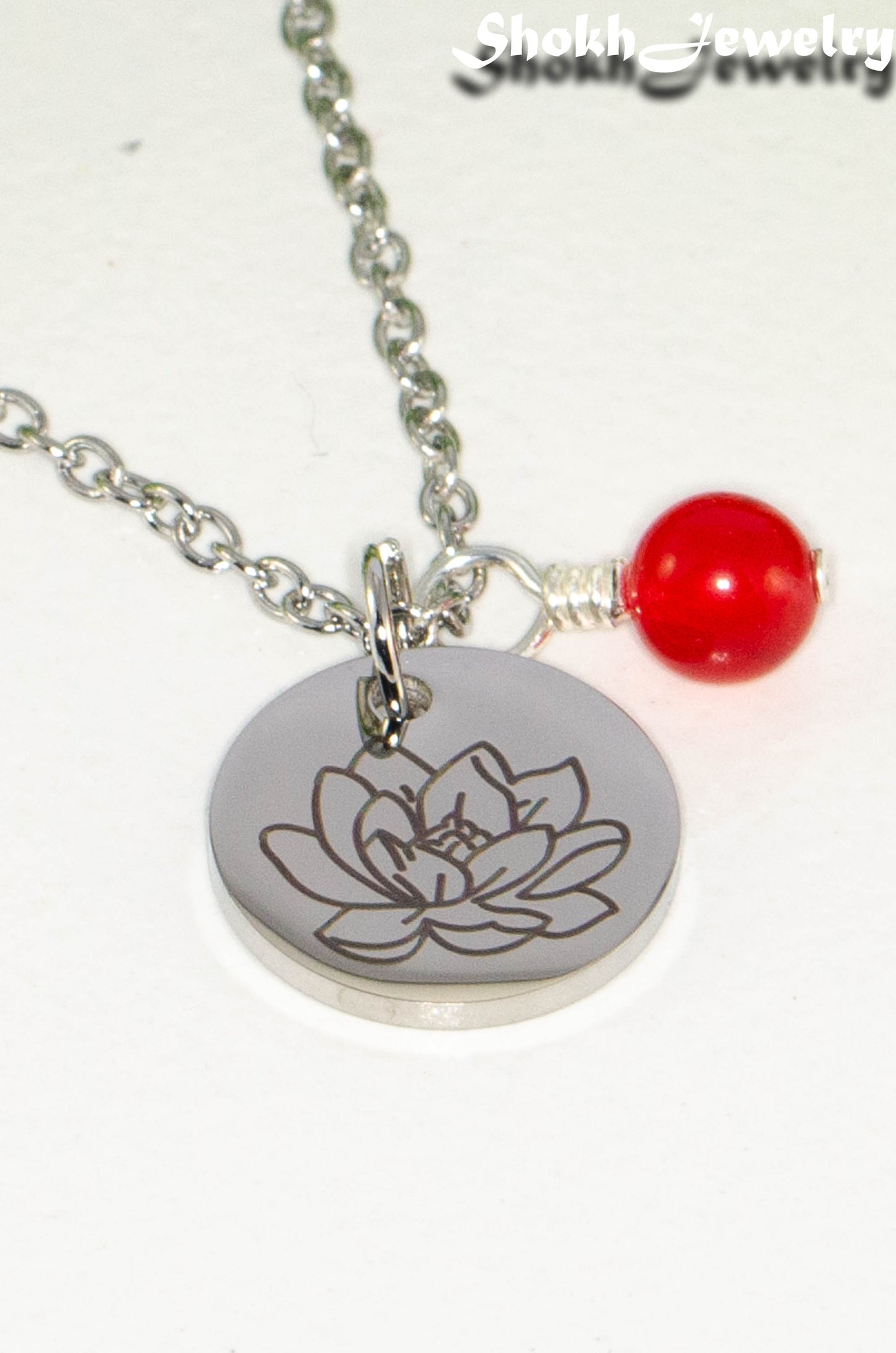 Close up of July Birth Flower Necklace with Red Ruby Birthstone Pendant.