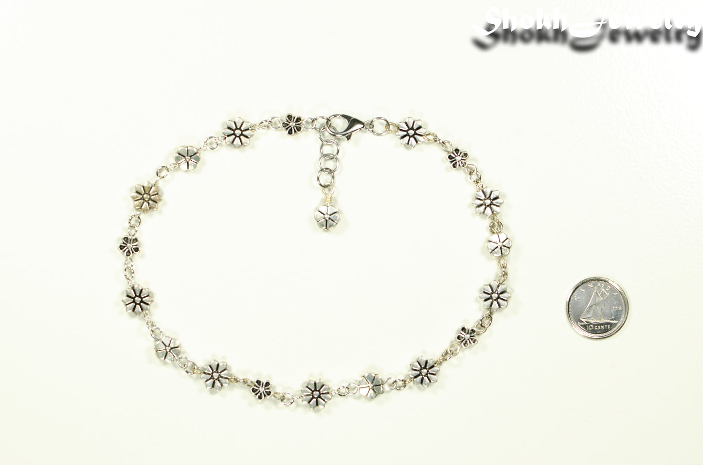 Dainty Tibetan Silver Flower Choker Necklace beside a dime.