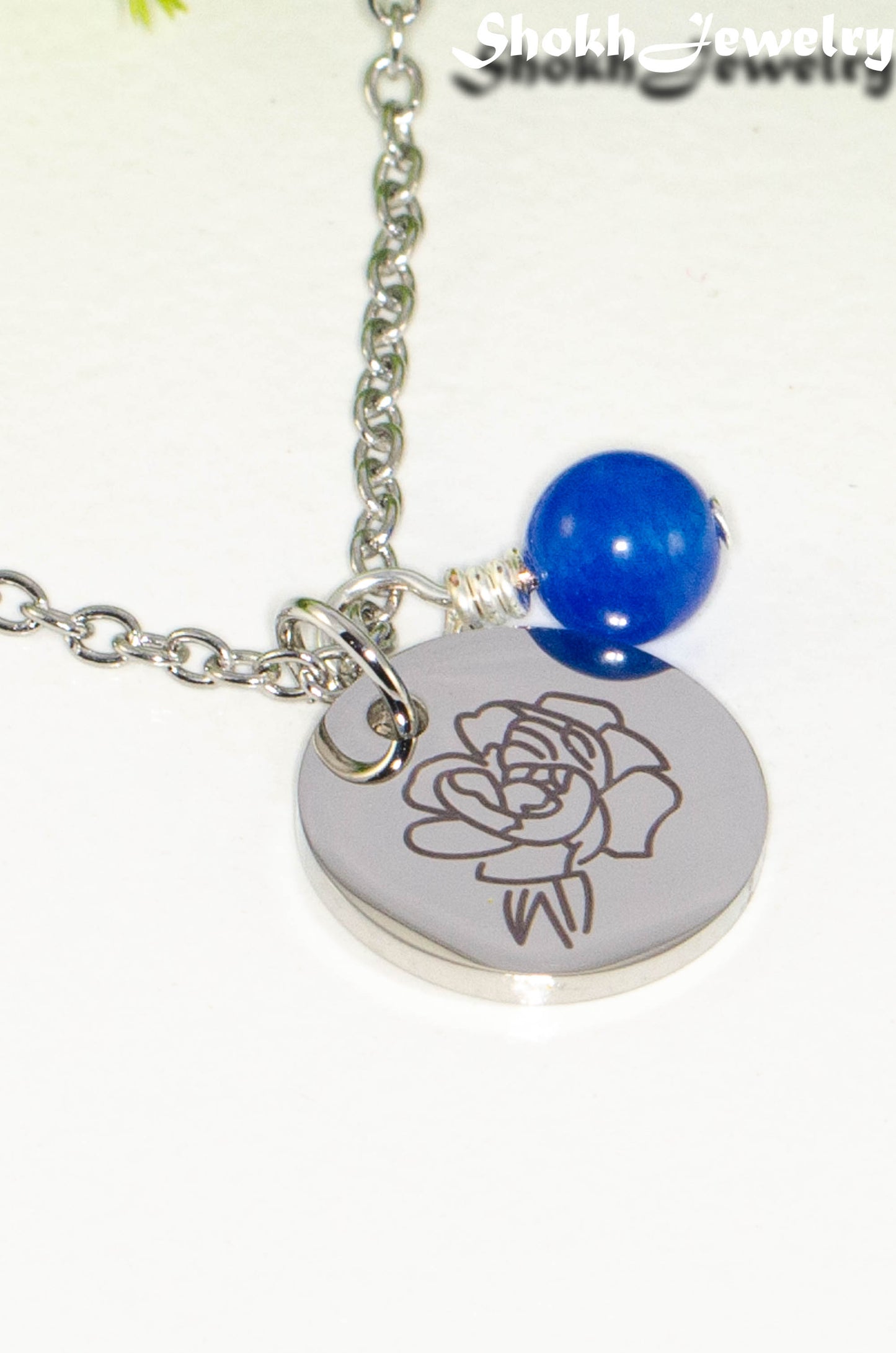 Close up of September Birth Flower Necklace with Sapphire Birthstone Pendant