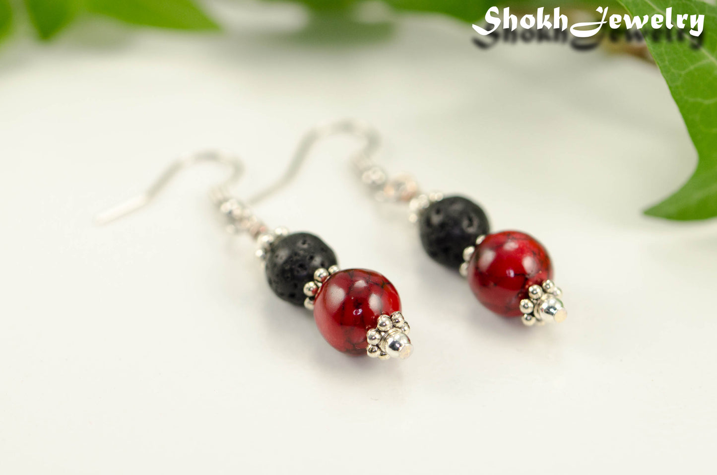 Close up of Red Quartzite and Black Lava Rock Earrings.