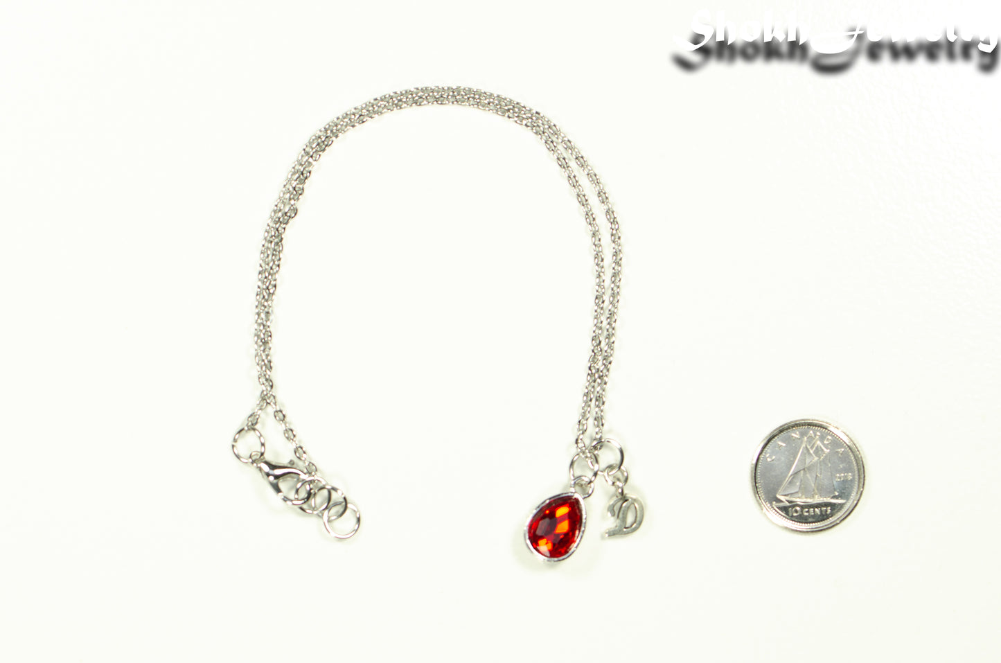 Small Personalized January Birthstone Choker Necklace beside a dime.