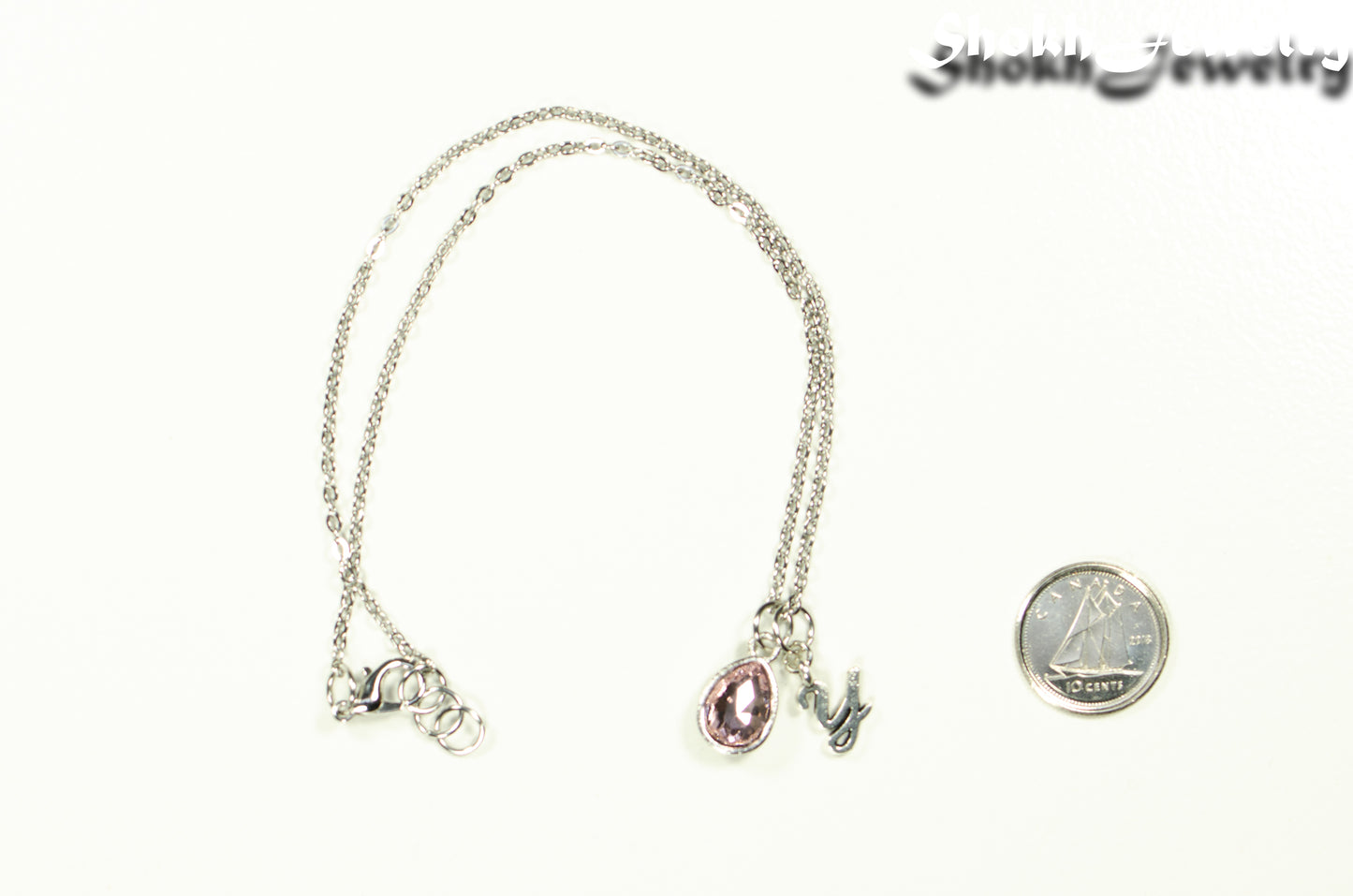 Small Personalized June Birthstone Choker Necklace beside a dime.