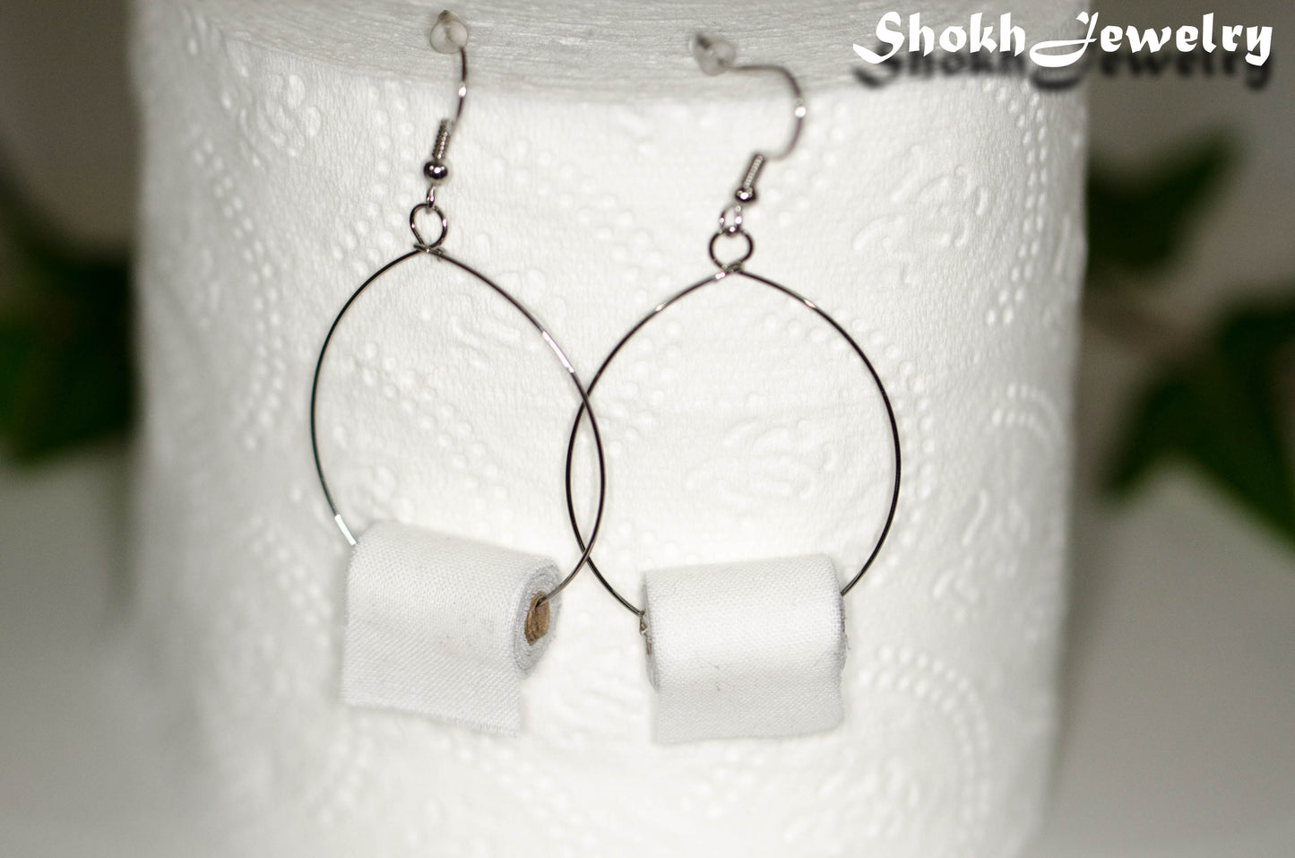 Large Miniature Toilet Paper Roll Earrings displayed on a toilet paper roll.