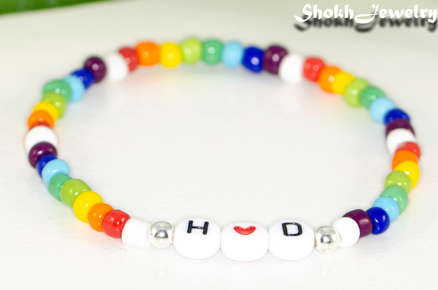 Close up of Rainbow seed beads Bracelet with Initials.