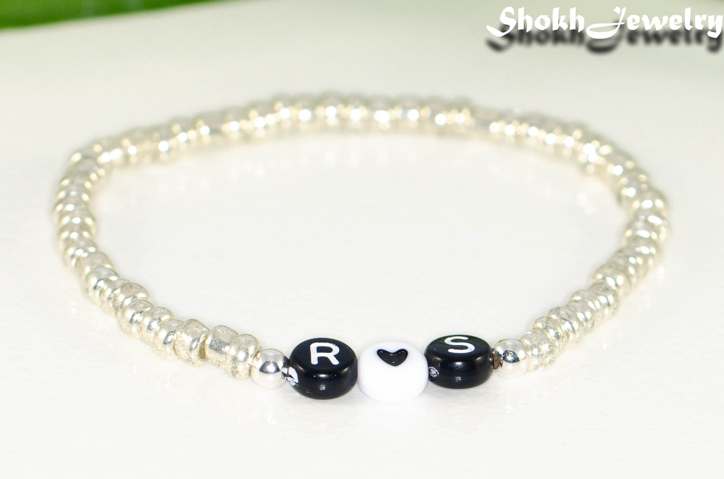 Close up of Silver Seed Beads Bracelet with Initials.
