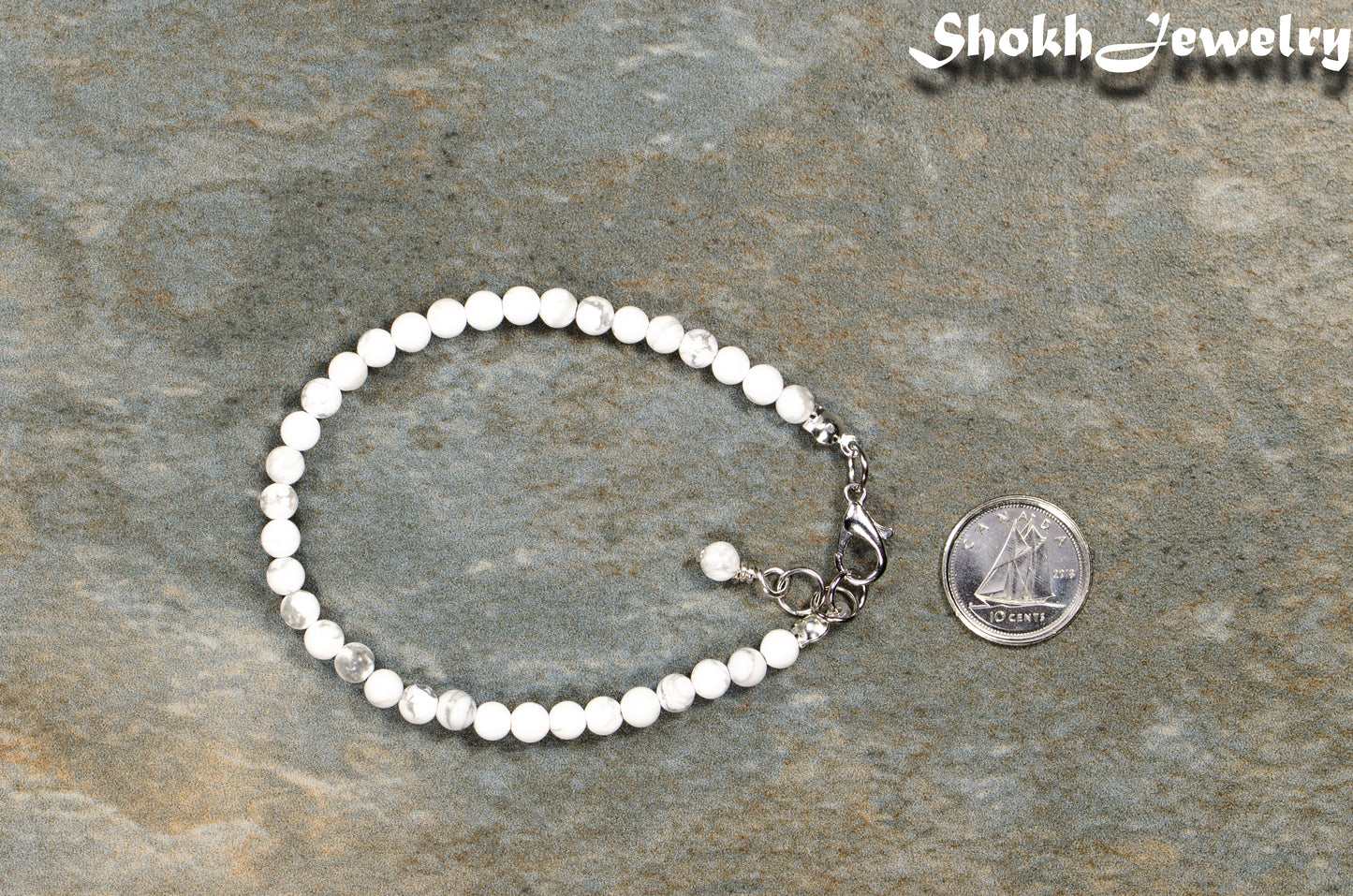 4mm White Howlite Bracelet with Clasp beside a dime.