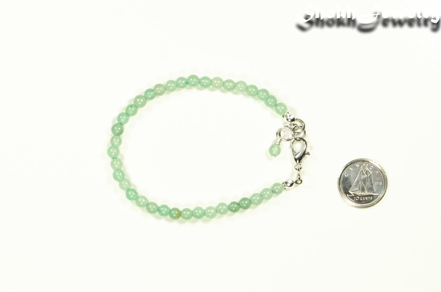 4mm Green Aventurine Bracelet with Clasp beside a dime.