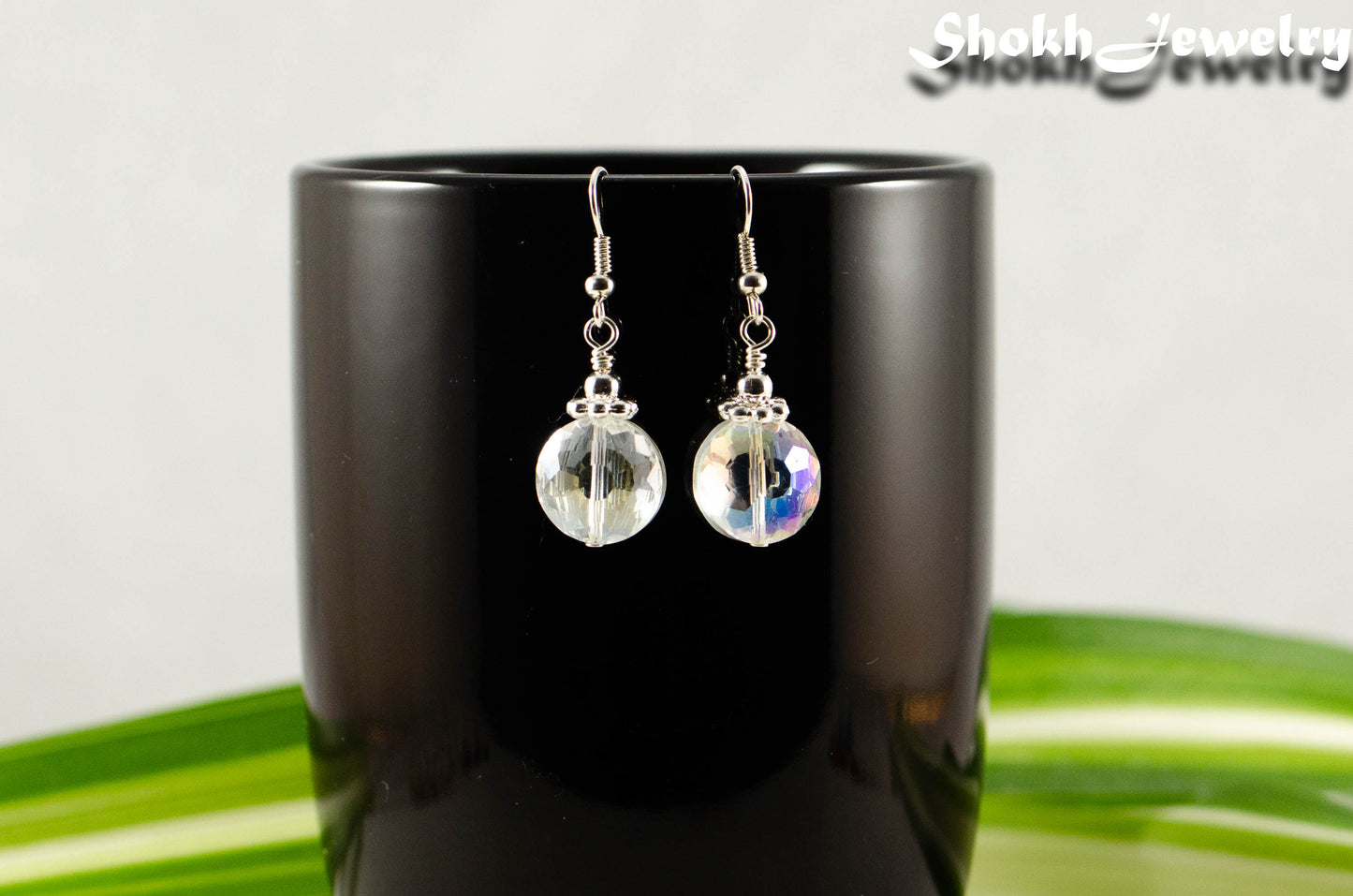 Clear AB Glass Crystal Beads Earrings displayed on a coffee mug.