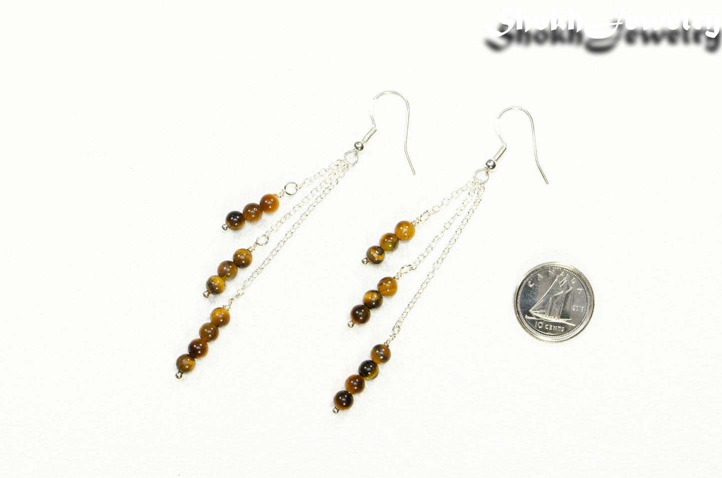 Silver Plated Chain and Tiger's Eye Stone Earrings beside a dime.