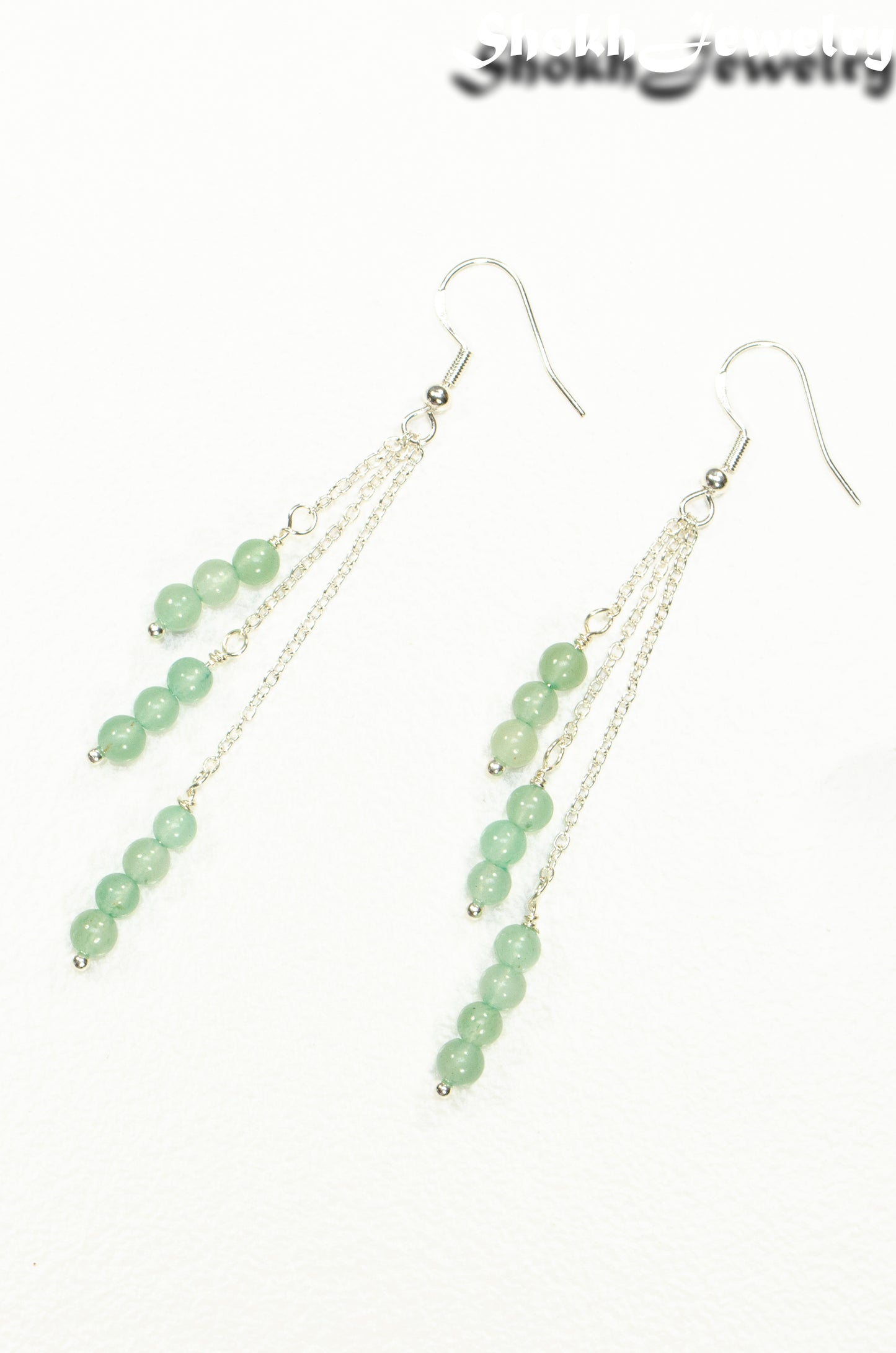 Top view of Silver Plated Chain and Green Aventurine Crystal Earrings.