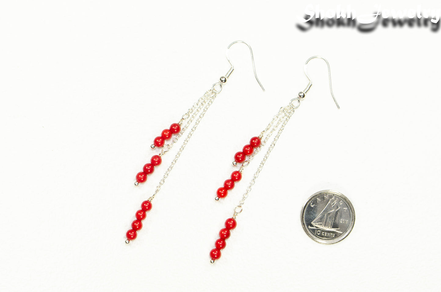 Silver Plated Chain and Red Coral Earrings beside a dime.