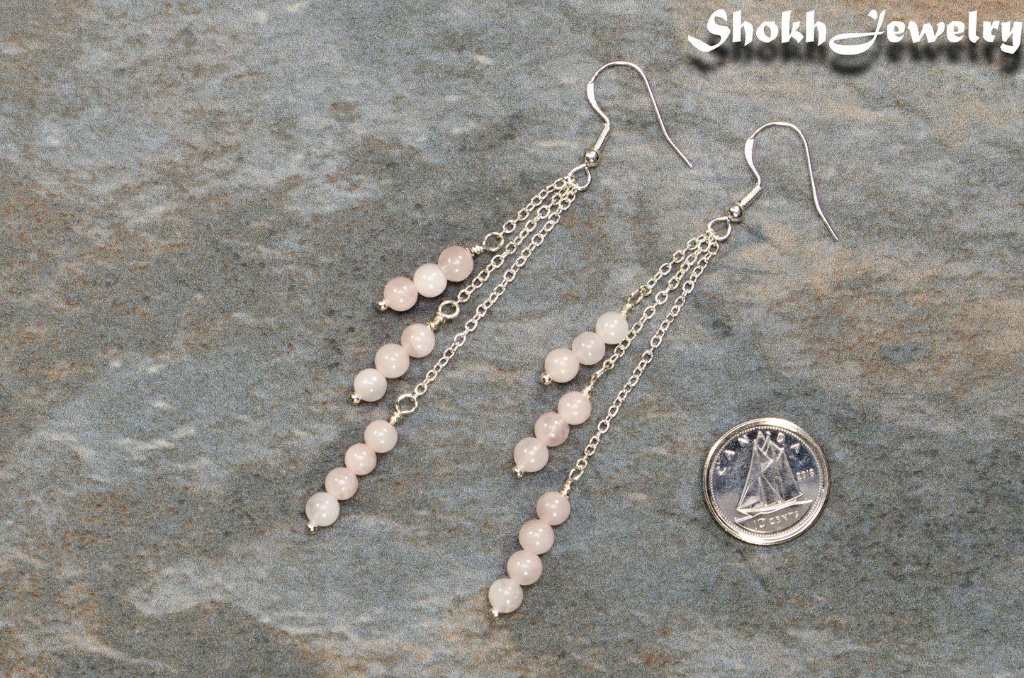 Silver Plated Chain and Rose Quartz Crystal Earrings beside a dime.