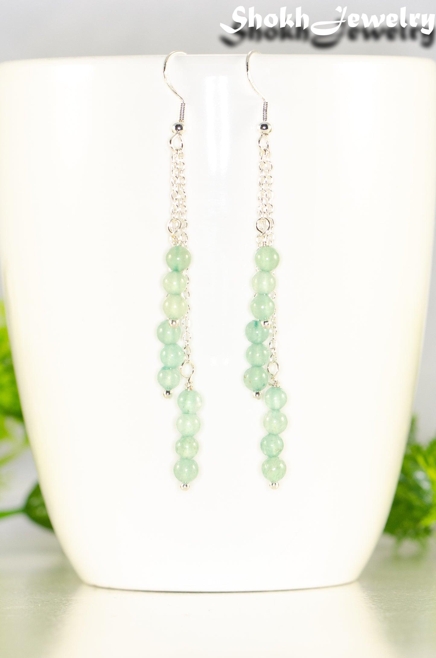 Close up of Silver Plated Chain and Green Aventurine Crystal Earrings.