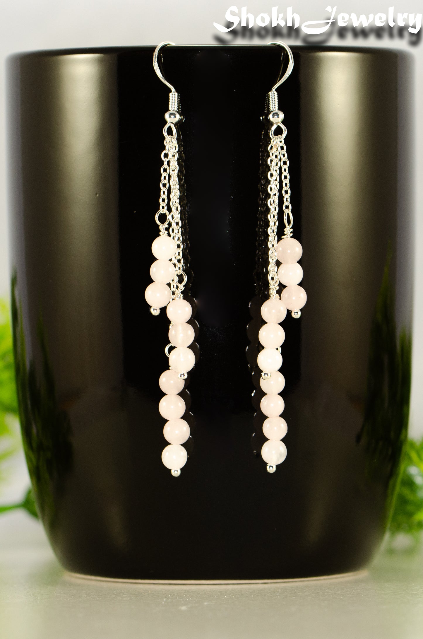 Close up of Silver Plated Chain and Rose Quartz Crystal Earrings.
