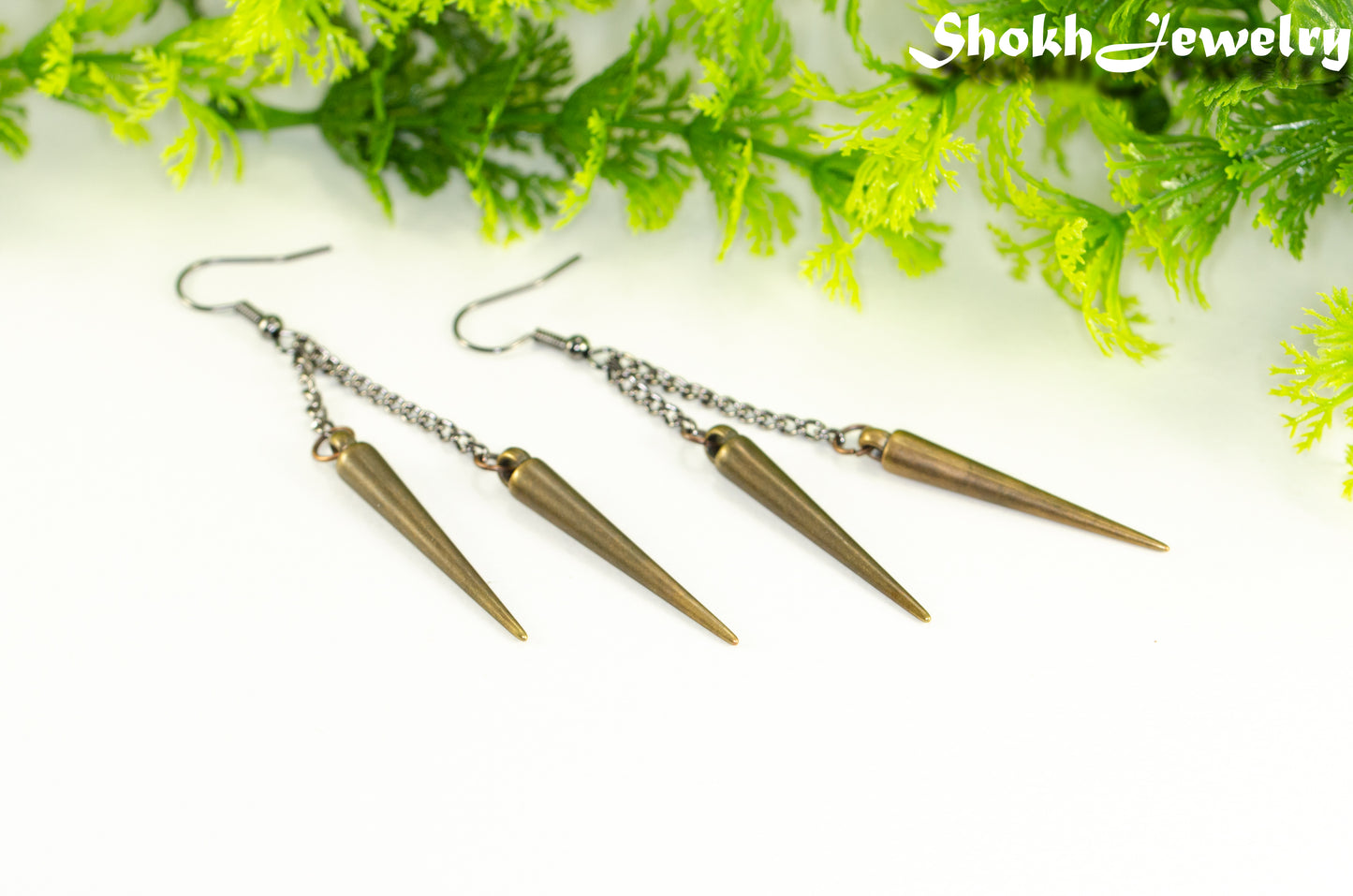 Long chain and antique bronze spike earrings.