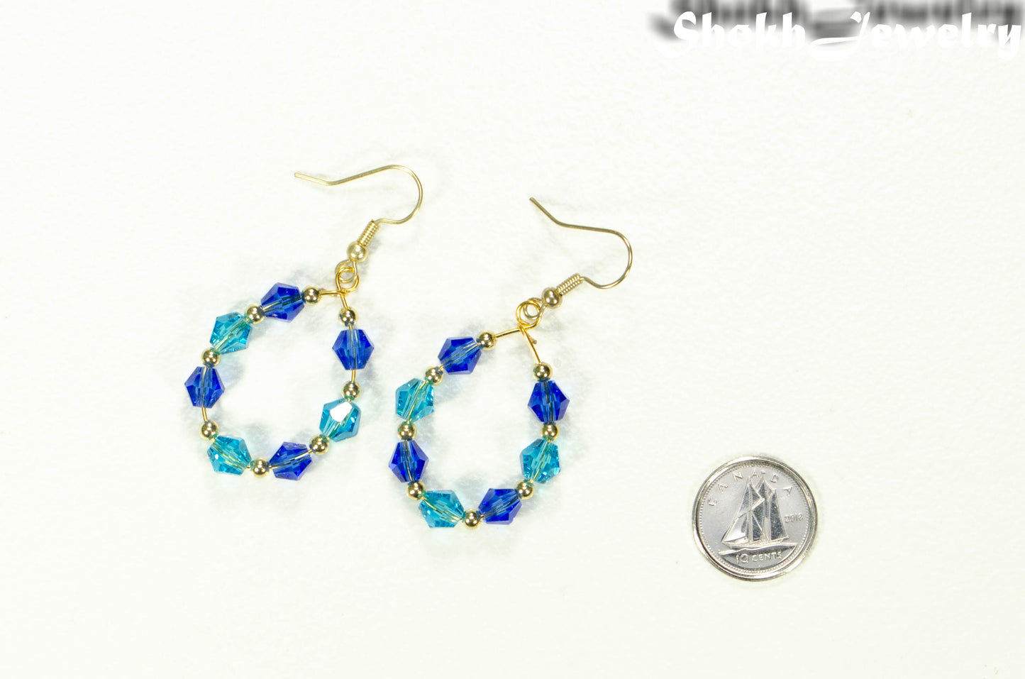 Blue Glass Crystal Hoop Earrings beside a dime.