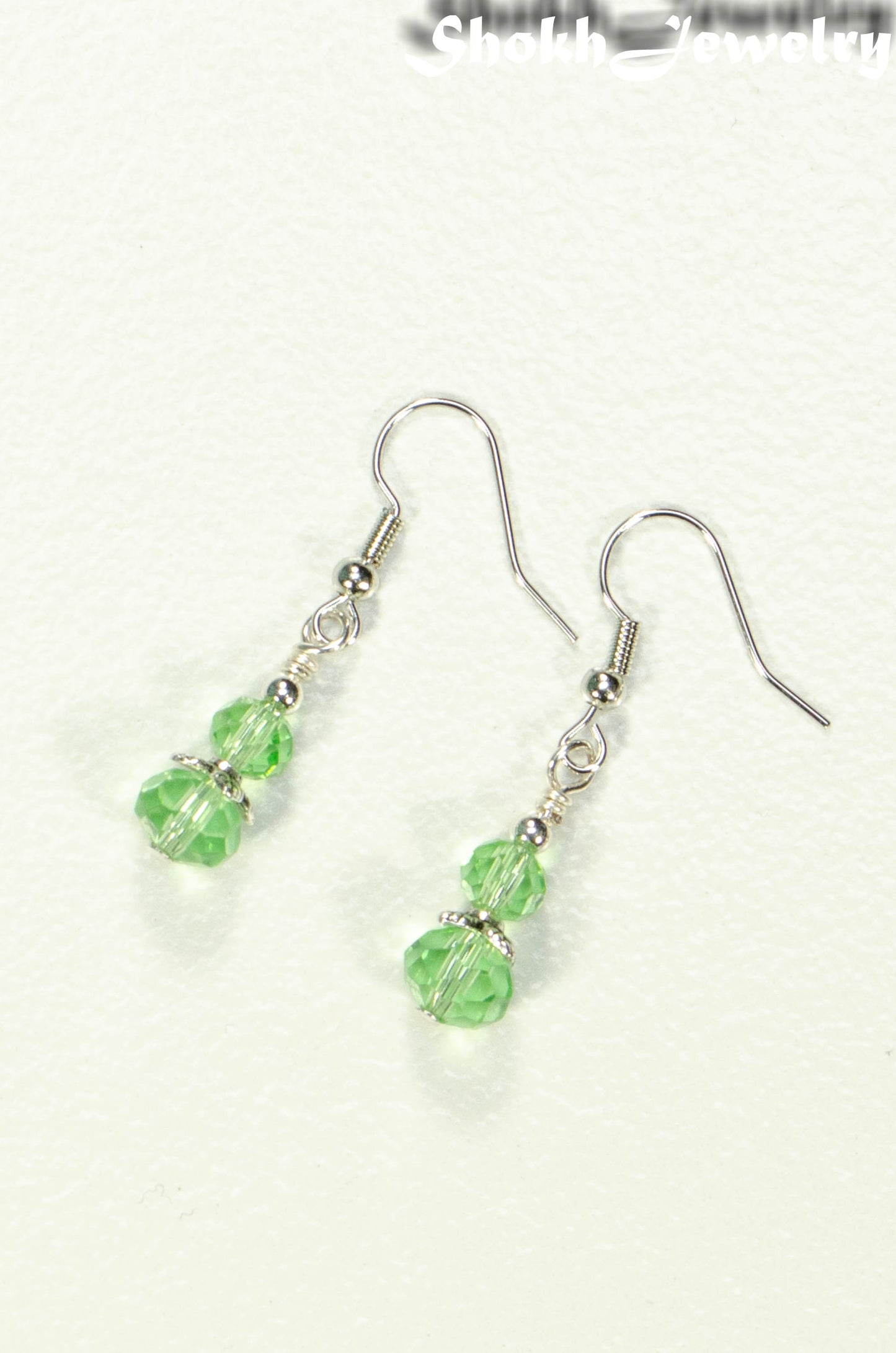 Top view of Small Light Green Glass Bead Dangle Earrings.