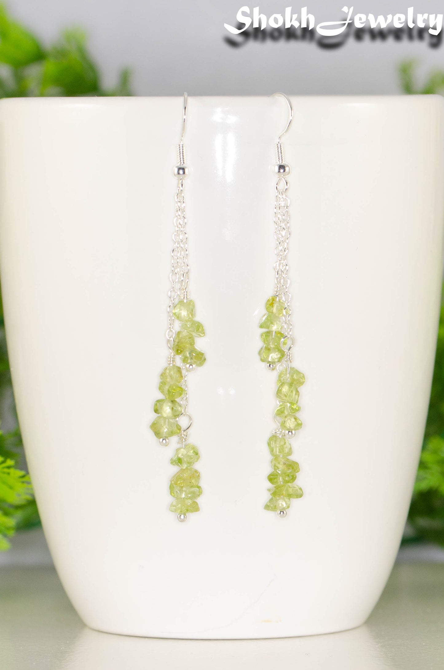 Close up of Long Silver Plated Chain and Peridot Chip Earrings.