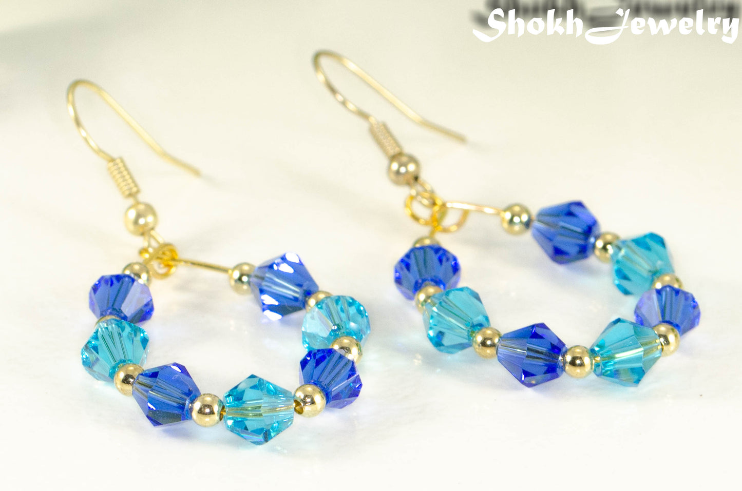 Close up of Blue Glass Crystal Hoop Earrings.