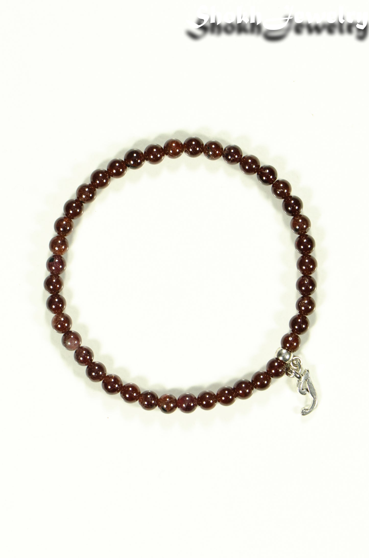 Top view of 4mm Garnet Bracelet with Initial.