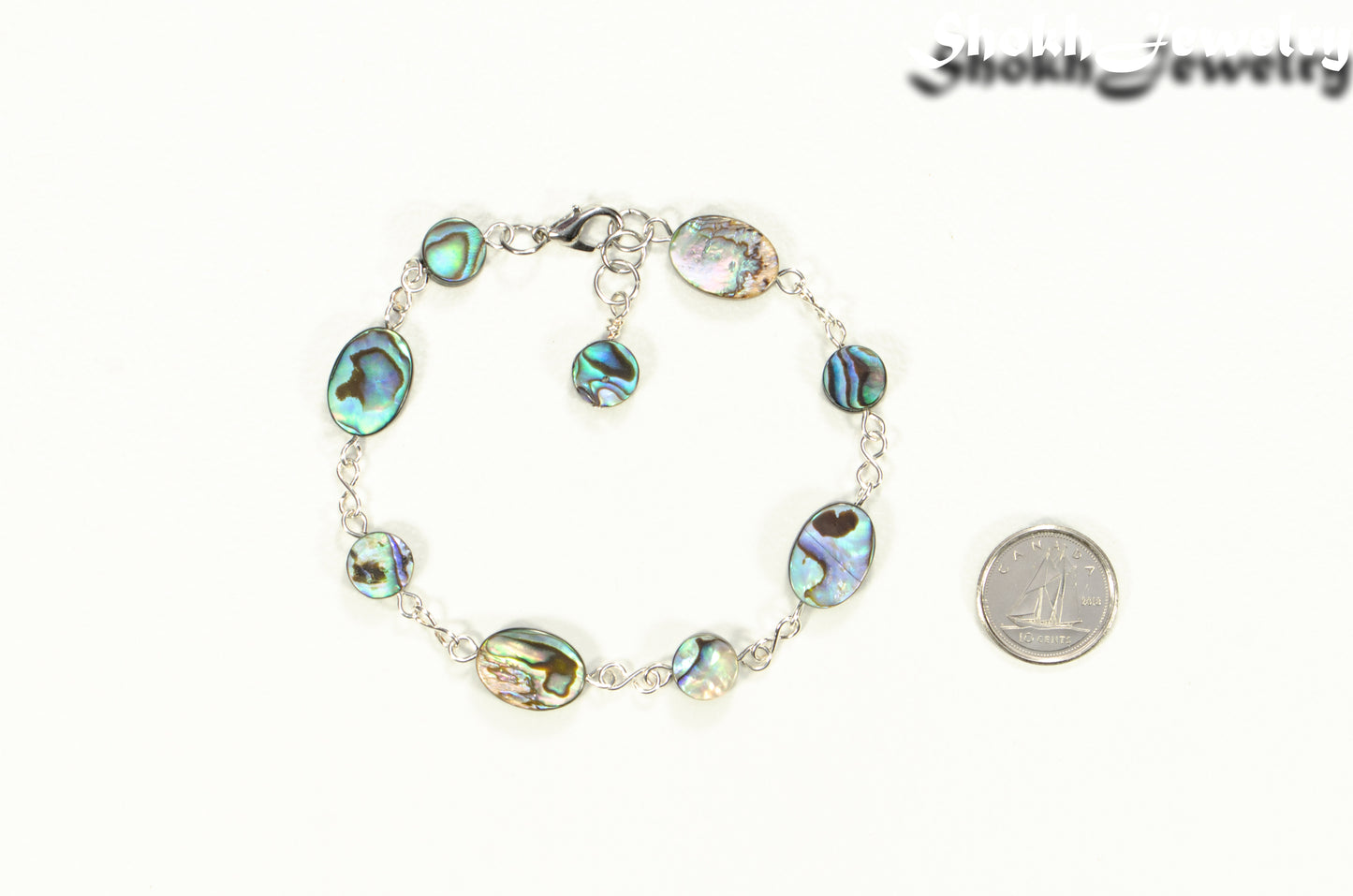 Natural Abalone Seashell Link Bracelet beside a dime.