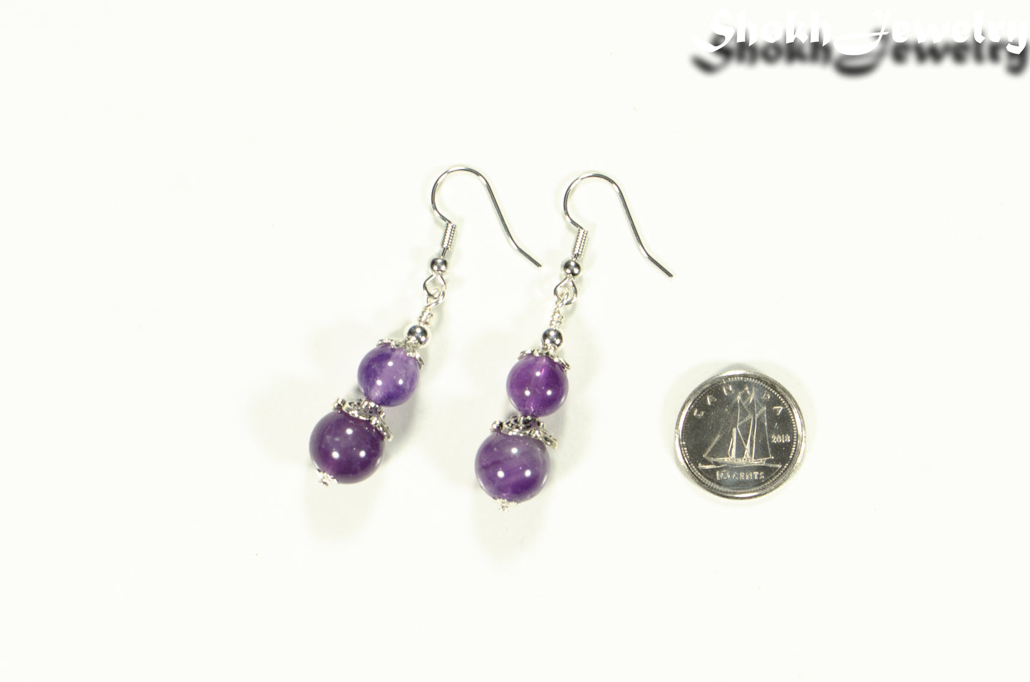Natural Amethyst Dangle Earrings beside a dime.